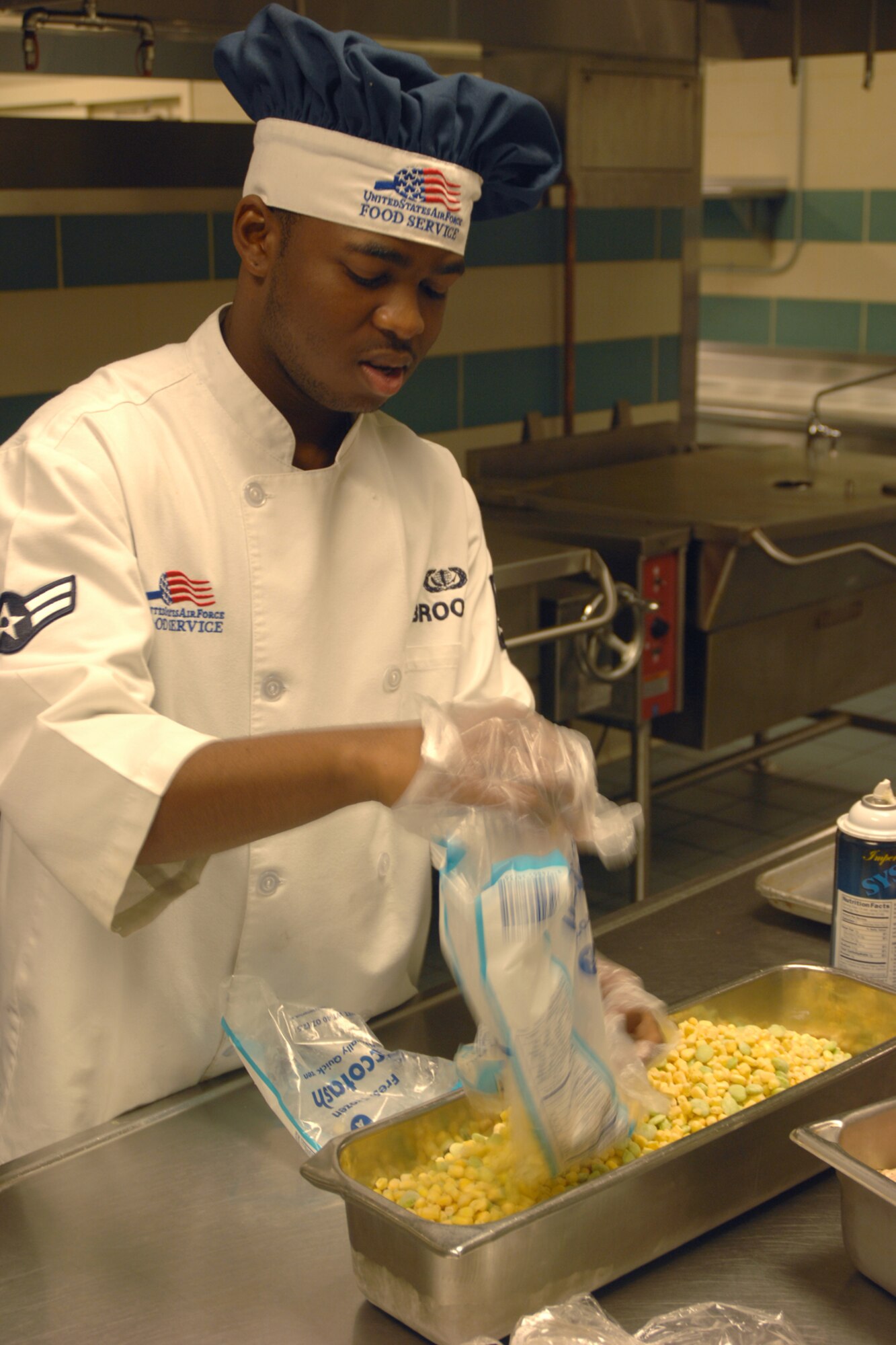 Airman 1st Class Derranda Brooks, 4th Force Support Squadron food service apprentice, prepares corn for dinner at the Southern Eagle Dining Facility on Seymour Johnson Air Force Base, N.C., June 16, 2009. Airman Brooks has worked at the dining facility for more than a year and customer service is his favorite part of the job. (U.S. Air Force photo by 2nd Lieutenant Joel Banjo-Johnson)