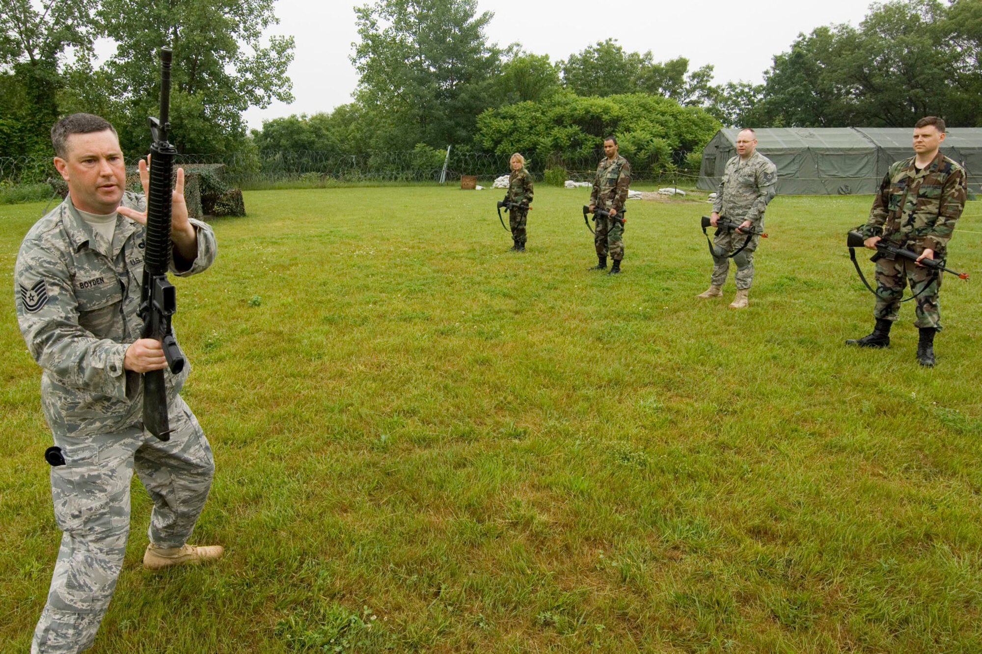 Tech. Sgt. William Boyden (left), 66th Security Forces Squadron trainer, demonstrates a right side block with an M-16 rifle while conducting a rifle fighting training session at Camp Patriot June 12. Rifle fighting training is part of Hanscom's Expeditionary Airman Combat Skills training, a pre-deployment course which teaches Airmen critical combat and survival skills.  (U.S. Air Force photo by Rick Berry)