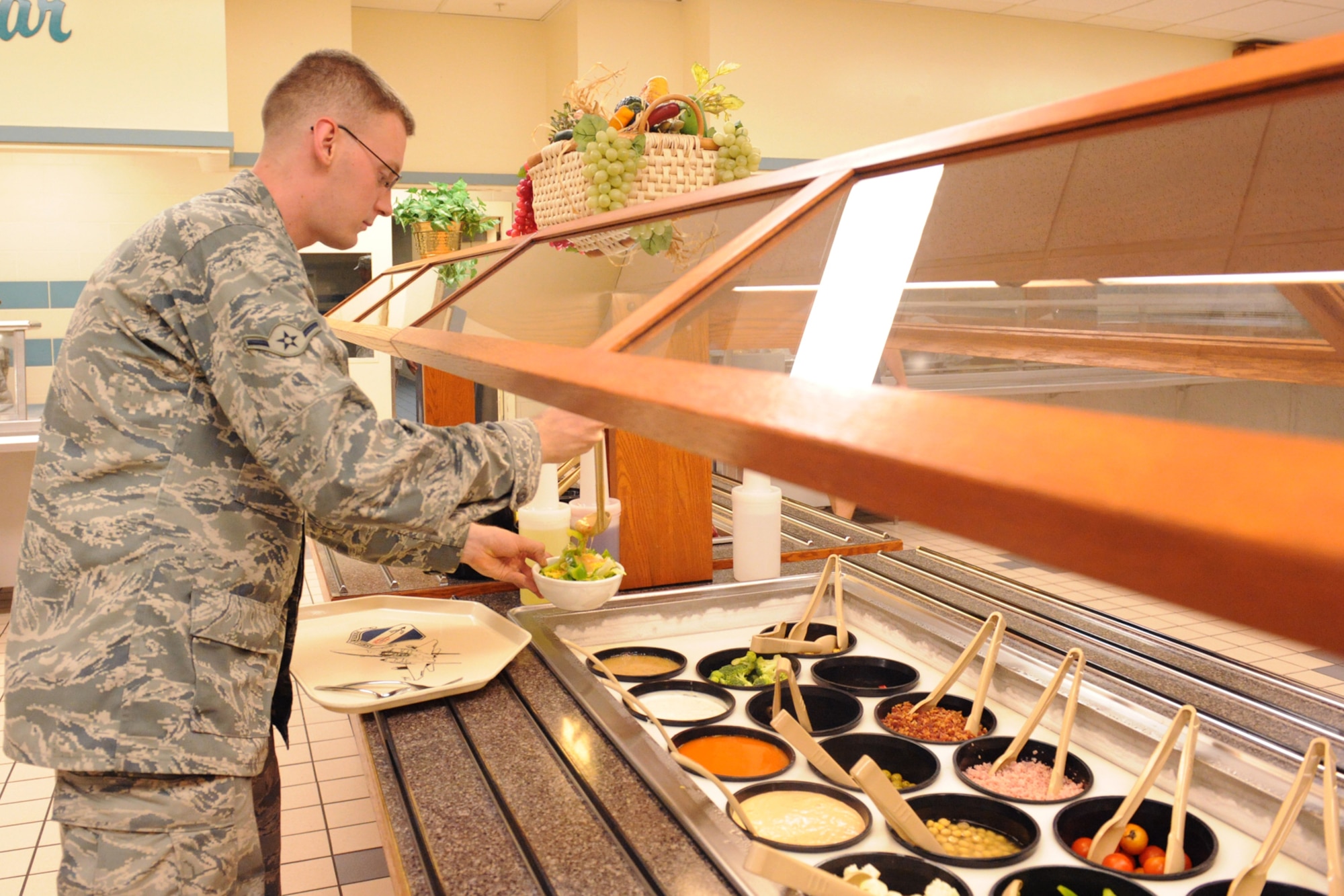 Airman Thomas Kendall, 4th Logistics Readiness Squadron, makes a salad at the Southern Eagle Dining Facility on Seymour Johnson Air Force Base, N.C., June 16, 2009. Airmen enjoy eating at the dining facility because of its convenient location to the dorms. (U.S. Air Force photo by Airman 1st Class Whitney S. Lambert)