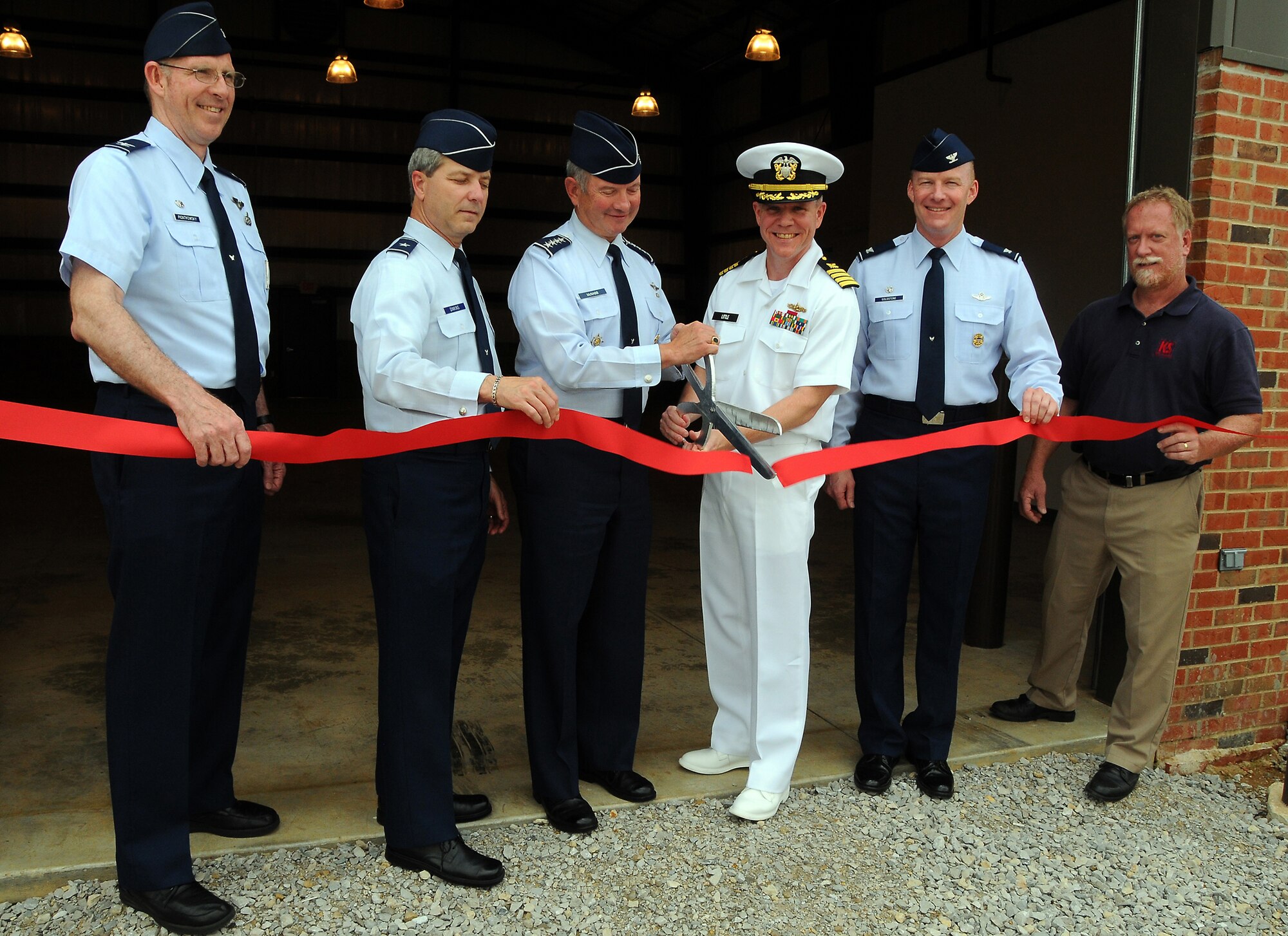 SCOTT AIR FORCE BASE, Ill. --  U.S. Transportation Command and Scott officials cut a ribbon June 10 to open a new 4,300-square-foot, $700,000 warehouse.  The building will be used by USTRANSCOM and Military Surface Deployment and Distribution Command for receiving and distribution of automated data processing equipment.  Pictured left to right are Col. Curt Piontkowsky, 375th Communications Group commander, Brig. Gen. Rick Dinkins, director USTRANSCOM Command Control Communications and Computer Systems, Gen. Duncan J. McNabb, USTRANSCOM commander, Capt. Bob Little, SDDC chief of staff, Col. Gary Goldstone, 375th Airlift Wing commander, and Rick Voght, K&S Associates Inc. (Photo courtesy/ Bob Fehringer)