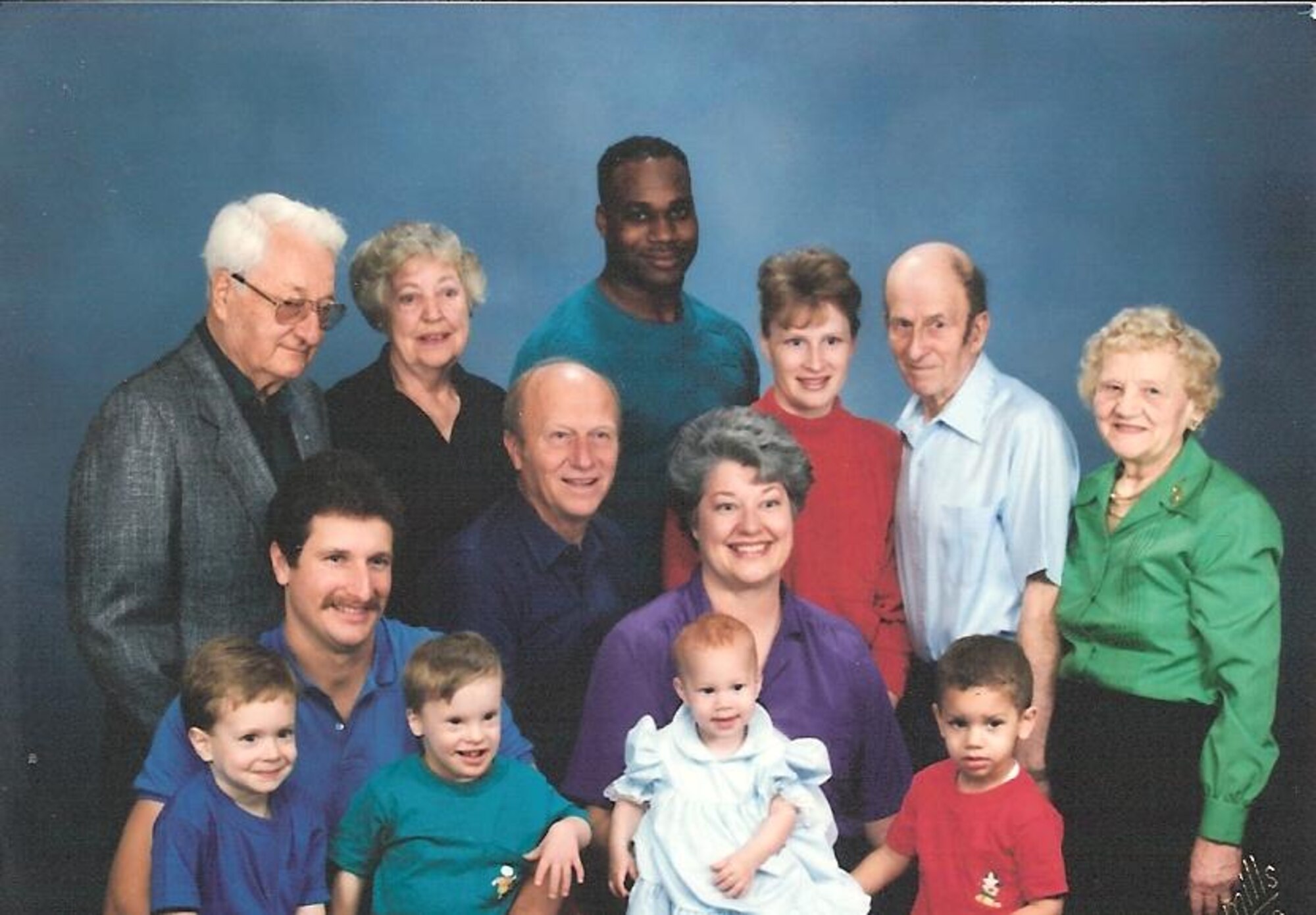 Airman 1st Class Anna Davis, Knowledge Operations Manager with the 87th Mission Suport Group on Joint Base McGuire-Dix-Lakehurst, N.J., sits in the lap of a family member as a baby in a family photo. Airman Davis' father, in the rear at center, is standing next to her mother, right. "As far back as I can remember, I have always been close with my father, Airman Davis said. "Whenever my mom told me I couldn't do something, I would always run to my dad because I knew that the answer would never be 'no.' In any case throughout my childhood, I've always been able to go to my dad when I had issues, from the smallest paper cut to the biggest life-changing decision
like joining the Armed Forces. An enduring life lesson that I have learned from my father would be to take pride in what you do and be willing to sacrifice for something greater than yourself.  My father was in the Army and provided support during Operation Desert Storm back when I was an infant, almost 20 years ago.  Prior to
joining the military, I had heard so many stories from my dad--some positive, others not so much. But in any case, he always told me that if I was willing to sacrifice myself for a greater good, then that alone should make me proud. Years later, I followed in my father's footsteps, and I wear this uniform today with pride--pride in knowing what I do every day is supporting something greater than myself." (Courtesy photo/Airman 1st Class Davis)