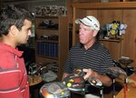 Wayn Whisenhunt (right), Randolph Oaks Golf Course, talks drivers with Bobby Gann at the course pro shop on June 16. The 12th Mission Support Squadron and 12th Services Division are merging June 26 to form the new 12th Force Support Squadron. (U.S. Air Force photo by Don Lindsey)