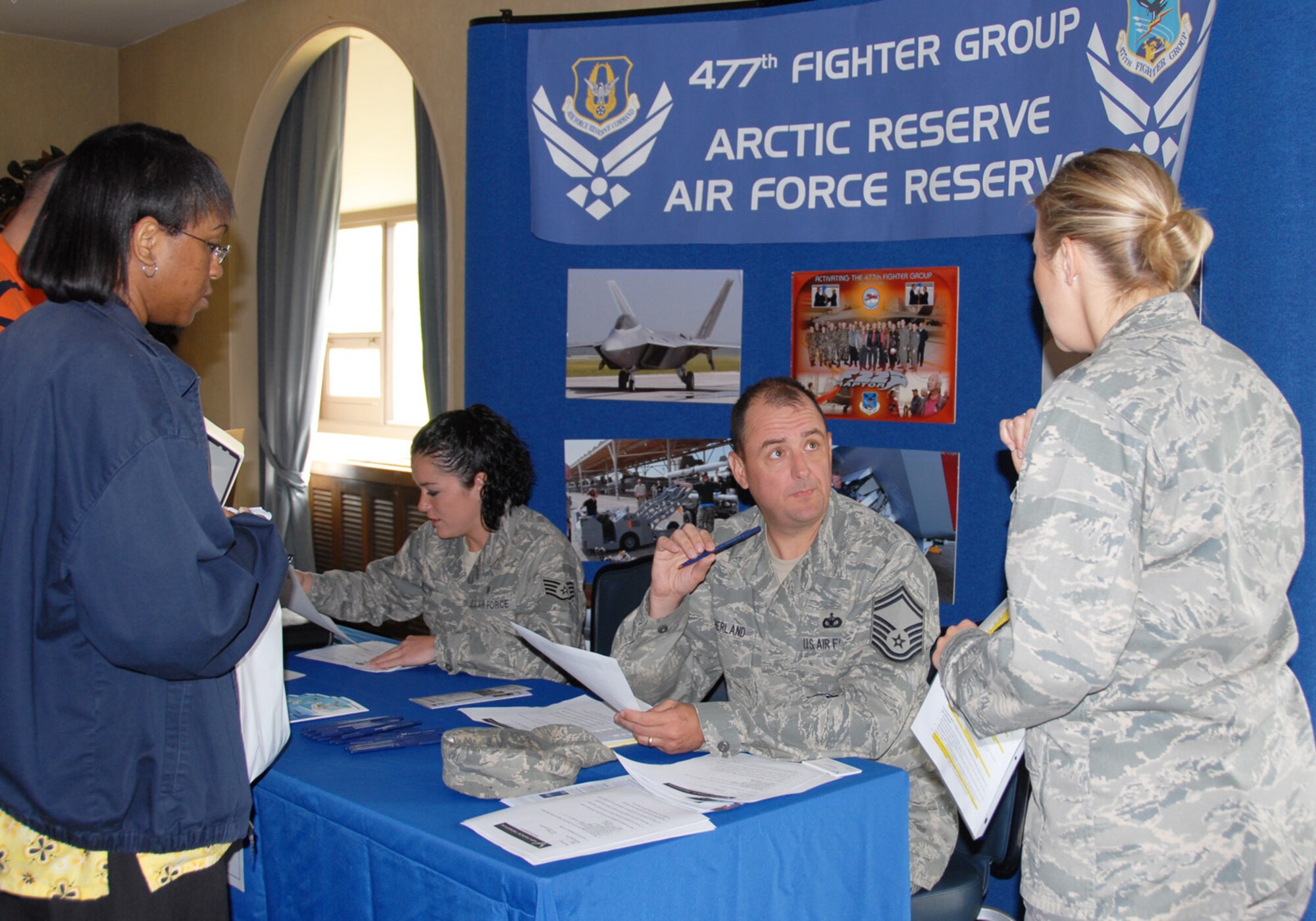 Recruiters from the 477th Fighter Group answer questions and provide information to Individual Ready Reserve members at a one-day IRR muster at Elmendorf Air Force Base, Alaska, June 12, 2009. Musters are designed to obtain updated contact information for IRR members and their availability for mobilization. (U.S. Air Force photo/Staff Sgt. Andrea Knudson)