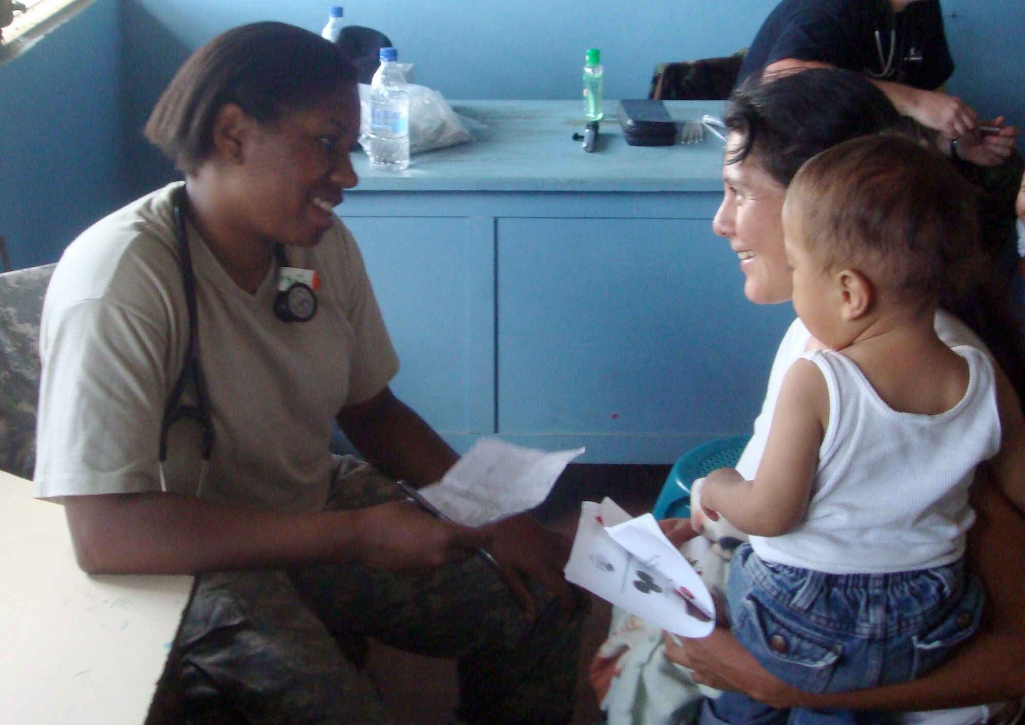 Pediatric resident Army Capt. (Dr.) Latanya Agurs (left) discusses  with the mother treatment and care  avaliable for her child during a medical readiness training exercise, or MEDRETE, May 18-29 in rural area of Honduras.  MEDRETE's bring health care to under-privileged children while provide training for medical personnel. (U.S. Air Force photo)                            