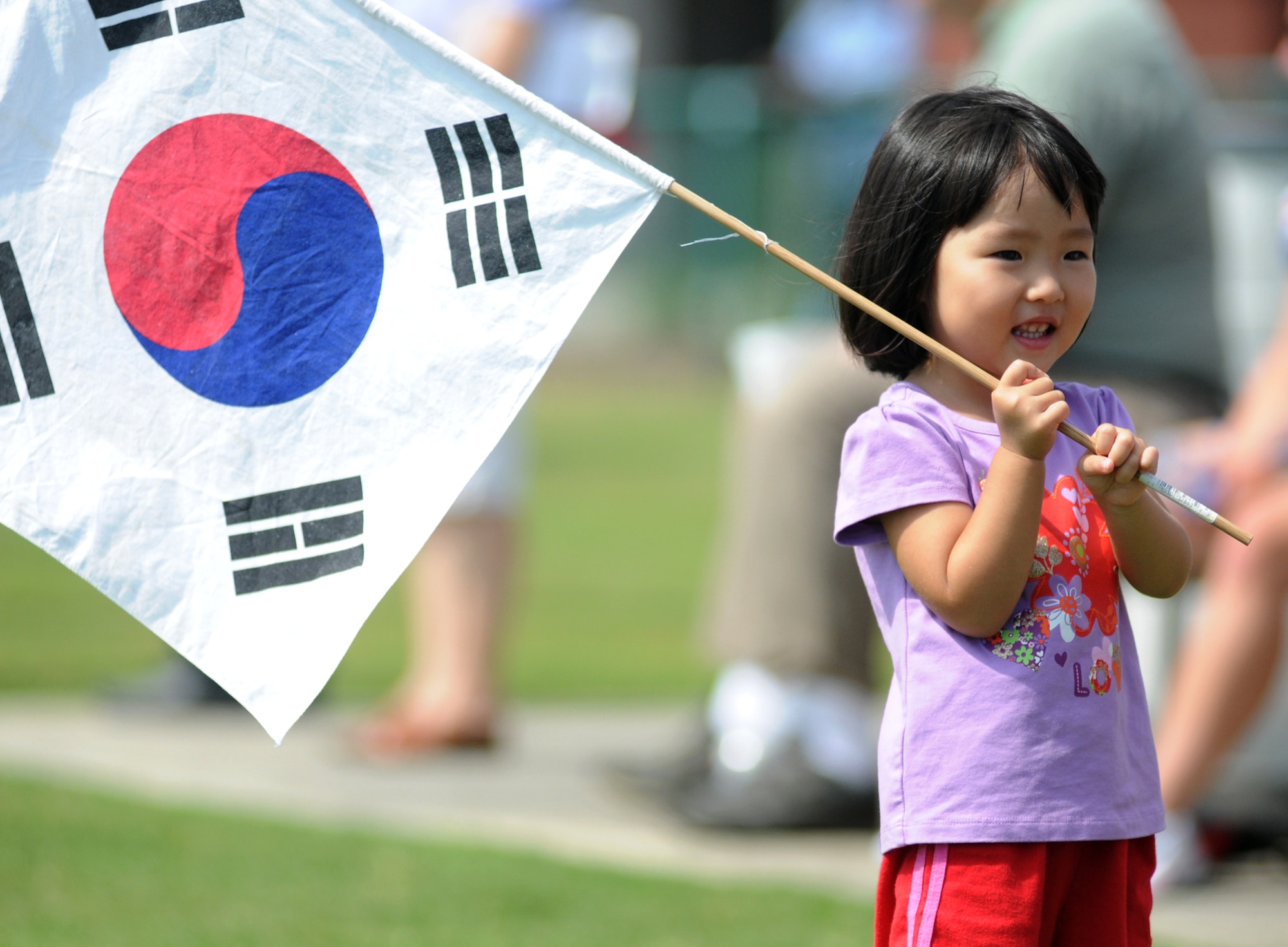 Two-year-old So Yeung Park cheers the Korean team during a June 9 game against Germany.  Her father is Senior Master Sgt. Jin Hyung Park, a weather forecasting student in the 335th Training Squadron.  (U.S. Air Force photo by Kemberly Groue)
