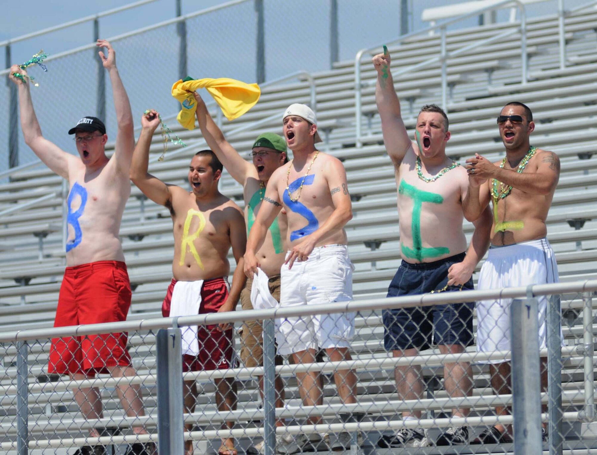 From left, Jacob Tarver, David MacDonald, Caleb Foy, Christopher Turknett and Juan Rivera cheer on the Brazilian team to a 1-0 victory during the title game of the Counseil du International Sports Militaire women’s soccer championship tournament at Biloxi High Stadium.  The cheering squad is from the 81st Security Forces Squadron.  The 81st SFS was only one of the units on base that ‘adopted’ one of the seven teams that competed.  Keesler hosted the international soccer showcase which began June 6 and ended Saturday.  (U.S. Air Force photo by Kemberly Groue)