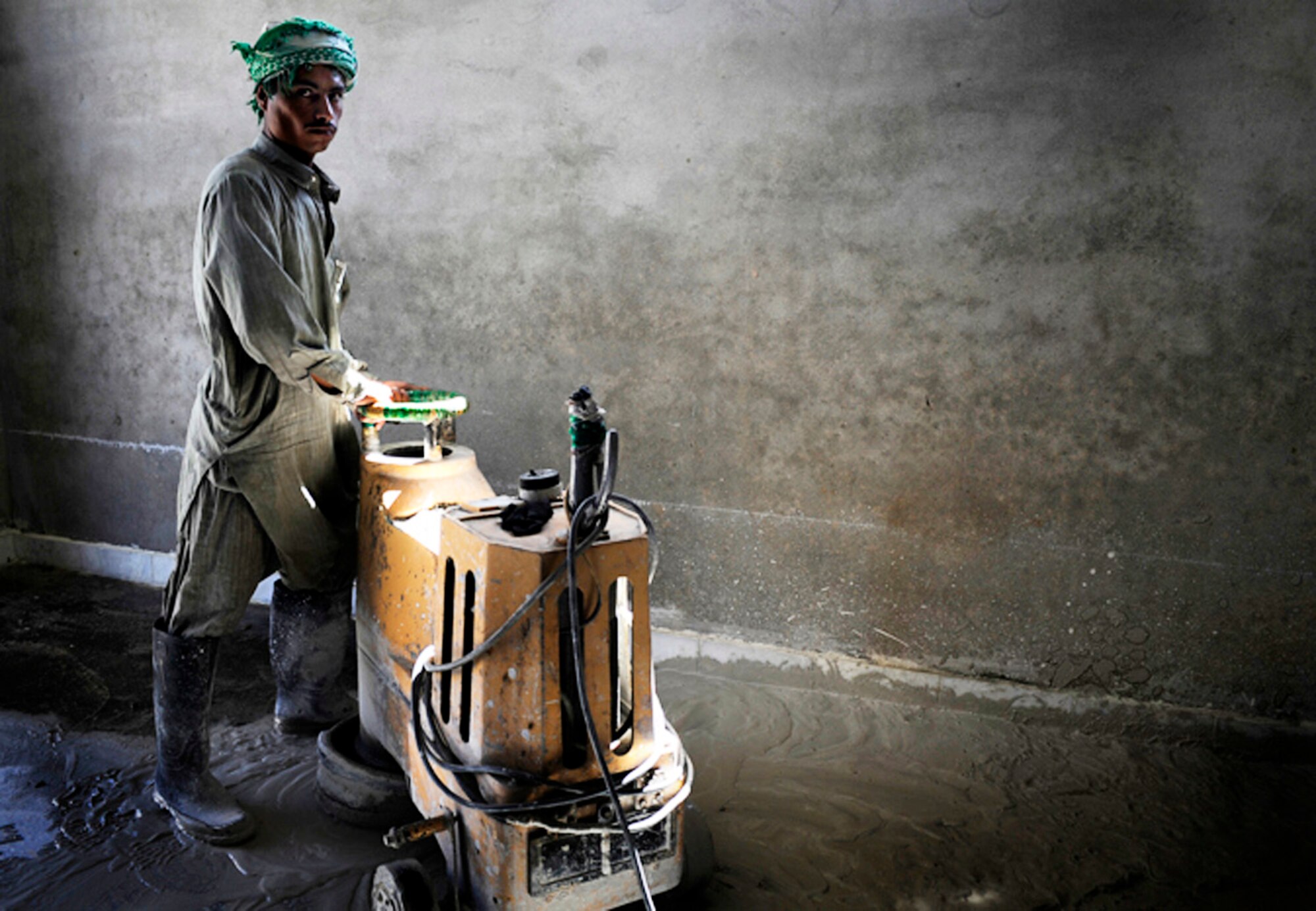 A local contractor spreads concrete for a development site May 30, Nangarhar Province Afghanistan. The development is monitored by the Provincial Reconstruction Team, Forward Operating Base Finley-Shields, Nangarhar. The PRT is responsible for development and reconstruction projects in Nangarhar Province. The projects are built by local and contractors and are designed to improve the livelihood of the people living in the area. (U.S. Air Force photo/Staff. Sgt. Shawn Weismiller) 