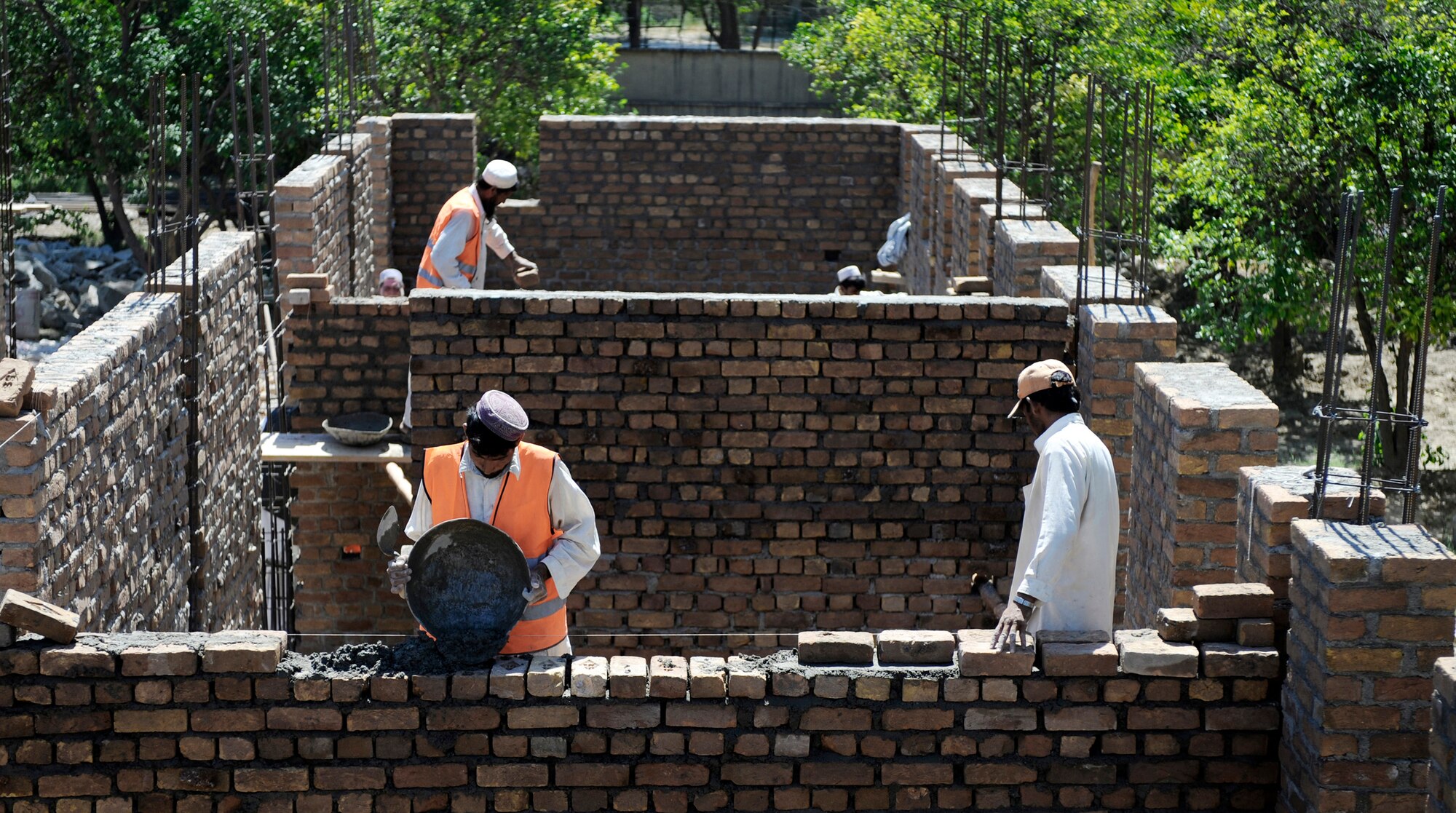 Local contractors spread mortar for a development site May 30, in Nangarhar Province, Afghanistan. The development is monitored by the Nangarhar Provincial Reconstruction Team, Forward Operating Base Finley-Shields, Afghanistan. The PRT is responsible for development and reconstruction projects in Nangarhar Province. The projects are built by local and contractors and are designed to improve the livelihood of the people living in the area. (U.S. Air Force photo/Staff. Sgt. Shawn Weismiller) 