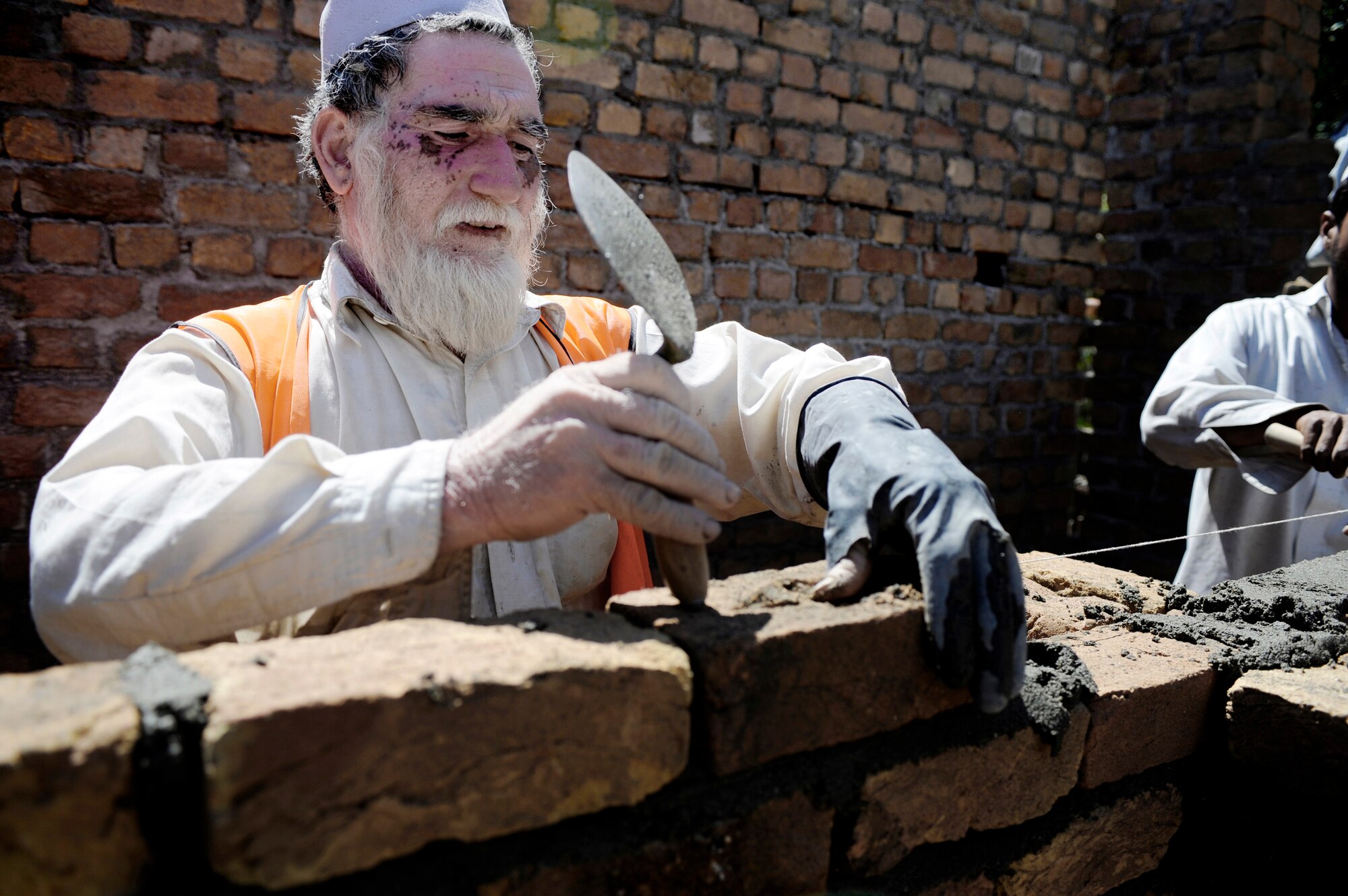 A local contractor spreads mortar for a development site May 30, in Nangarhar Province, Afghanistan. The development is monitored by the Nangarhar Provincial Reconstruction Team, Forward Operating Base Finley-Shields, Afghanistan. The PRT is responsible for development and reconstruction projects in Nangarhar Province. The projects are built by local and contractors and are designed to improve the livelihood of the people living in the area. (U.S. Air Force photo/Staff. Sgt. Shawn Weismiller)