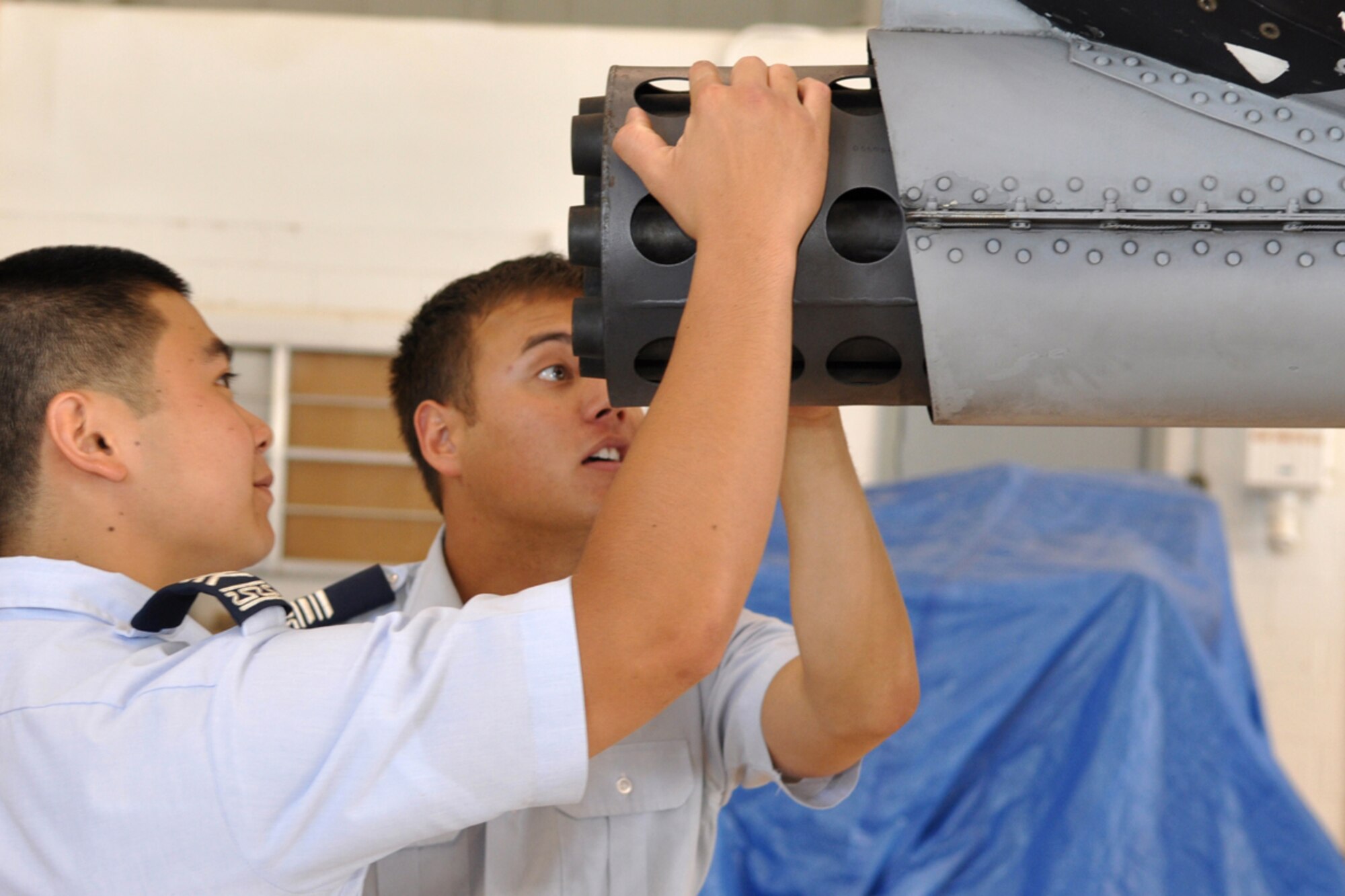 (L to R)Cadets Tony Onitsuka and John Kuconis get take a close look at the 30mm Gatling gun on an A-10 Thunderbolt jet at the A-10 Hangar at Barksdale Air Force Base, La., June 15, 2009. A small number of Air Force Academy cadets are spending three weeks of their summer at Barksdale learning about their future Air Force life from the inside. They are involved in a summer program called Operations Air Force, where cadets are “randomly chosen to integrate into Air Force bases” around the world.” One of the goals of the program is for the cadets to experience the Total Force Integration. The group of cadets also visited the 93rd Bomb Squadron where they were briefed on similar activities concerning the B-52 Stratofortress. Cadet Onitsuka is from Ewa Beach, Hawaii and is part of the Class of 2011. Cadet Kuconis calls Boston, Mass., home and is part of the Class of 2010. (U.S. Air Force photo/Tech. Sgt. Jeff Walston)