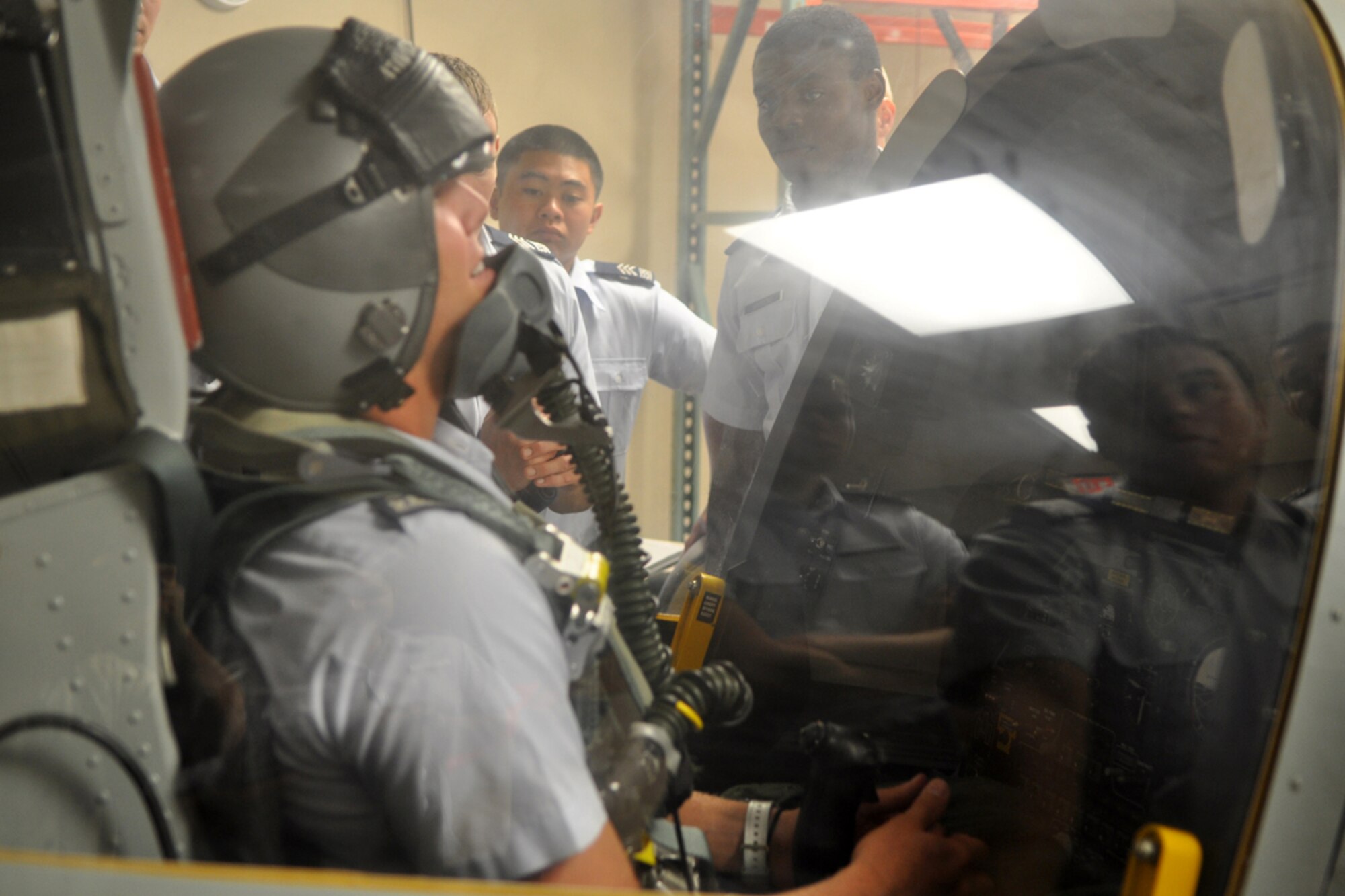U.S. Air Force Academy cadets look on as their classmate Cadet Stephen Vrabic, receives firsthand experience in the life support egress trainer at the 47th Fighter Squadron at Barksdale Air Force Base, La., June 15, 2009. A small number of Air Force Academy cadets are spending three weeks of their summer at Barksdale learning about their future Air Force life from the inside. They are involved in a summer program called Operations Air Force, where cadets are “randomly chosen to integrate into Air Force bases” around the world.” One of the goals of the program is for the cadets to experience the Total Force Integration. The cadets also visited the 93rd Bomb Squadron where they were briefed on similar activities concerning the B-52 Stratofortress. Cadet Vrabic, who calls Fort Lauderdale, Fla., his hometown, is part of the Class of 2011 at the U.S. Air Force Academy. (U.S. Air Force photo/Tech. Sgt. Jeff Walston)
