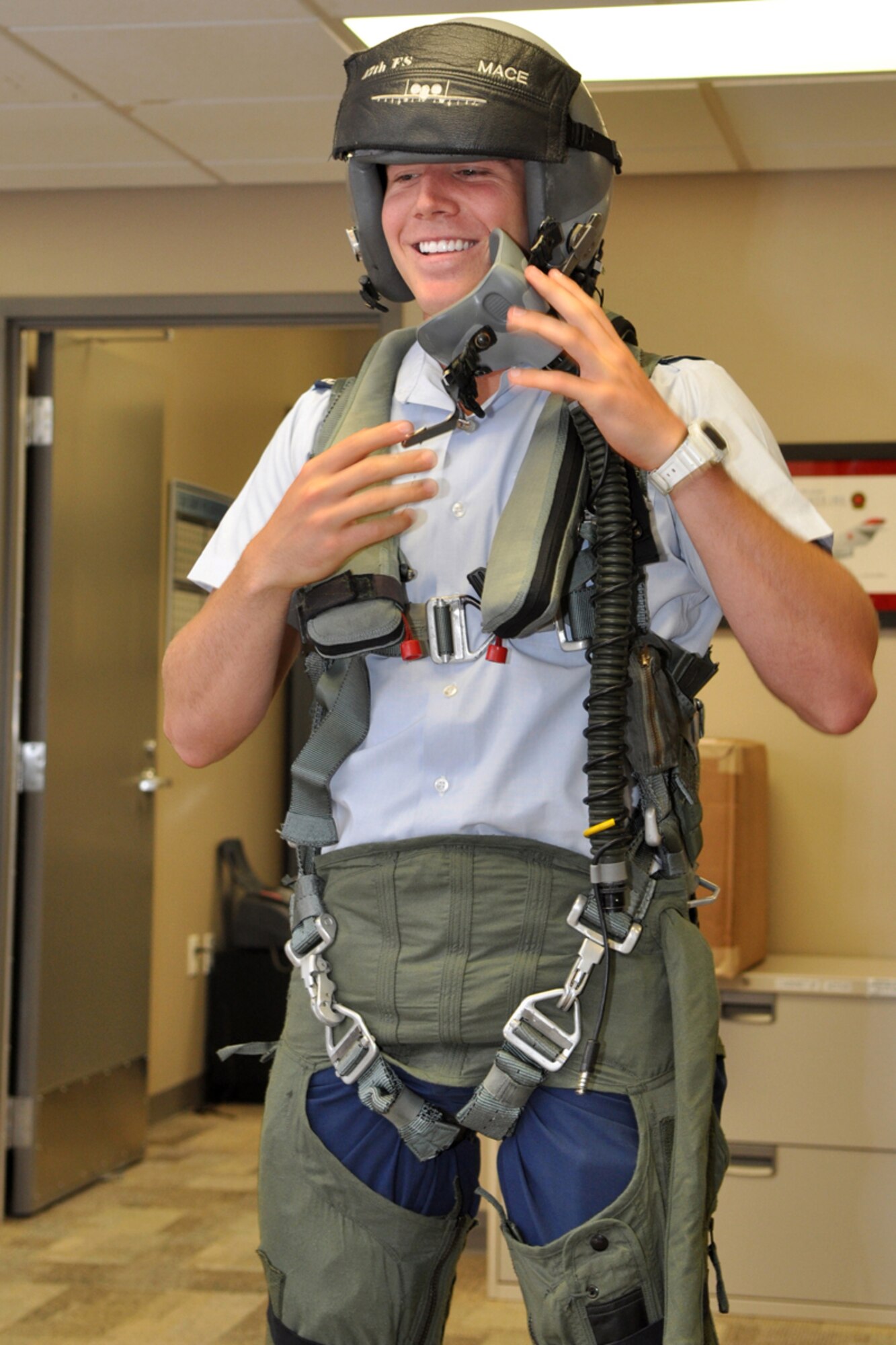 U.S. Air Force Academy Cadet Stephen Vrabic demonstrates the donning of an anti-G suit for his fellow cadets during a visit to the 47th Fighter Squadron at Barksdale Air Force Base, La., June 15, 2009. The G-suit, as it is also called, inflates around vital areas of the body such as the abdomen and thighs to hold blood in place to keep a pilot from blacking out or losing consciousness during flight. Cadet Vrabic, who is from Fort Lauderdale, Fla., is involved in a summer program called Operations Air Force, where cadets are “randomly chosen to integrate into Air Force bases” around the world.” One of the goals of the program is for the cadets to experience the Total Force Integration. Cadet Vrabic and his classmates also visited the 93rd Bomb Squadron where they were briefed on similar activities concerning the B-52 Stratofortress. Cadet Vrabic is part of the Class of 2011 at the U.S. Air Force Academy. (U.S. Air Force photo/Tech. Sgt. Jeff Walston)