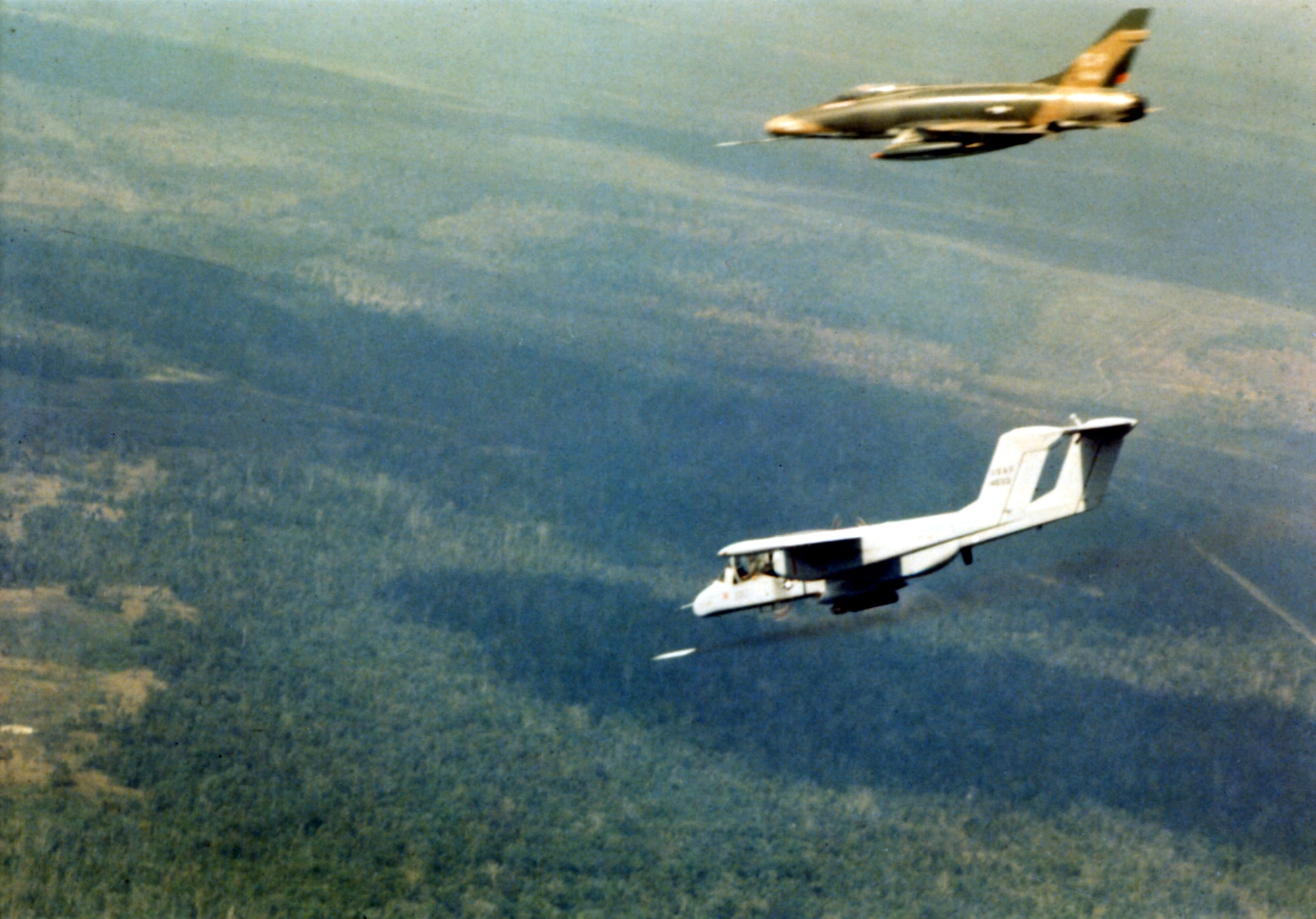 An OV-10A firing a smoke rocket in the area north of Saigon in February 1969 to show where the F-100 should drop its bombs. (U.S. Air Force photo)