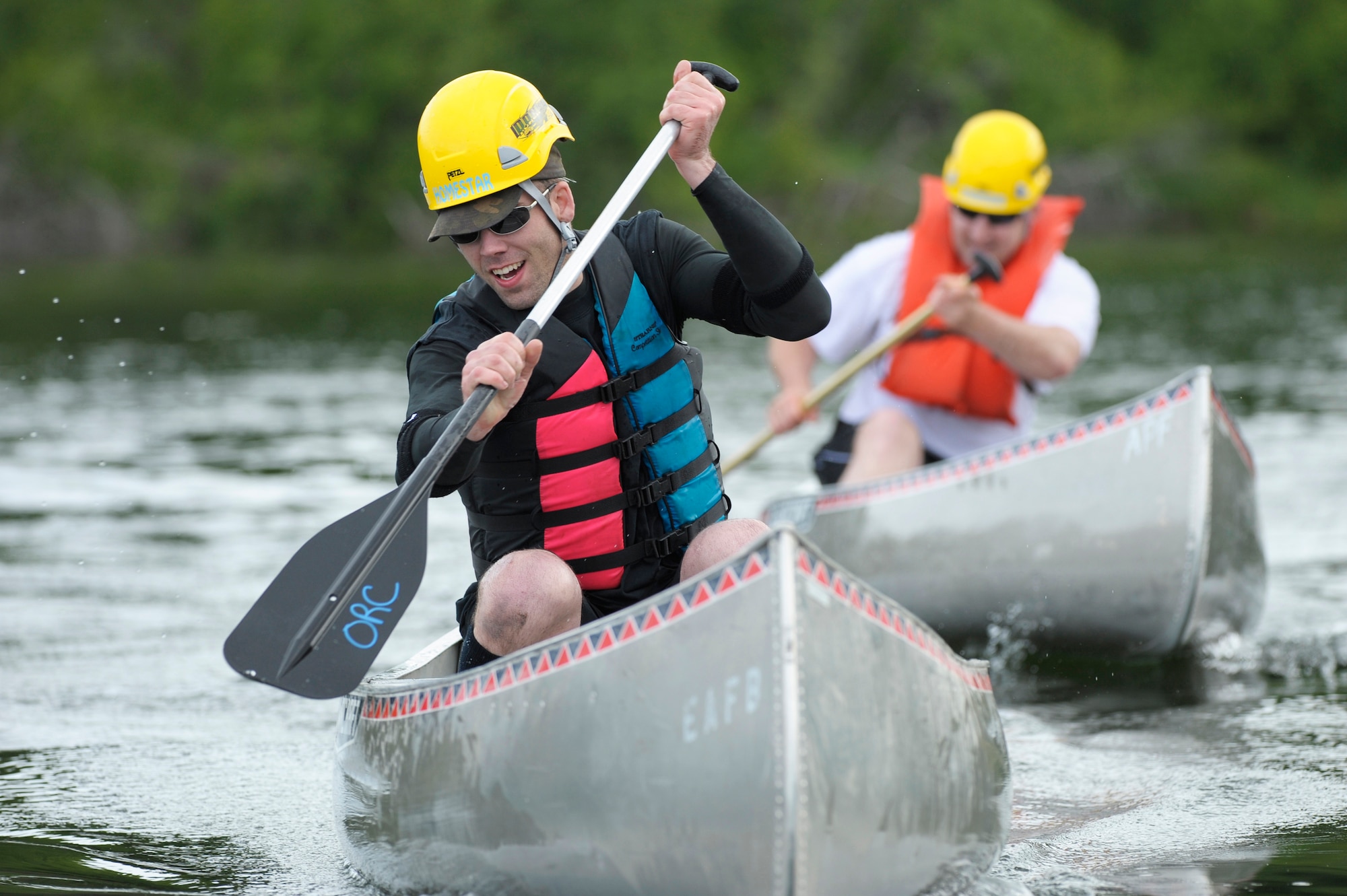 ELMENDORF AIR FORCE BASE, Alaska -- Senior Airmen Tyson Potter and Ryan Bollinger paddle their way to the finish line during the canoe race of the Arctic Warrior Olympics June 12. This year's canoe race course ran nearly 1,500 feet at Sixmile Lake here. Potter and Bollinger are members of 3rd Equipment Maintenance Squadron. (U.S. Air Force photo/Master Sgt. Keith Brown)
