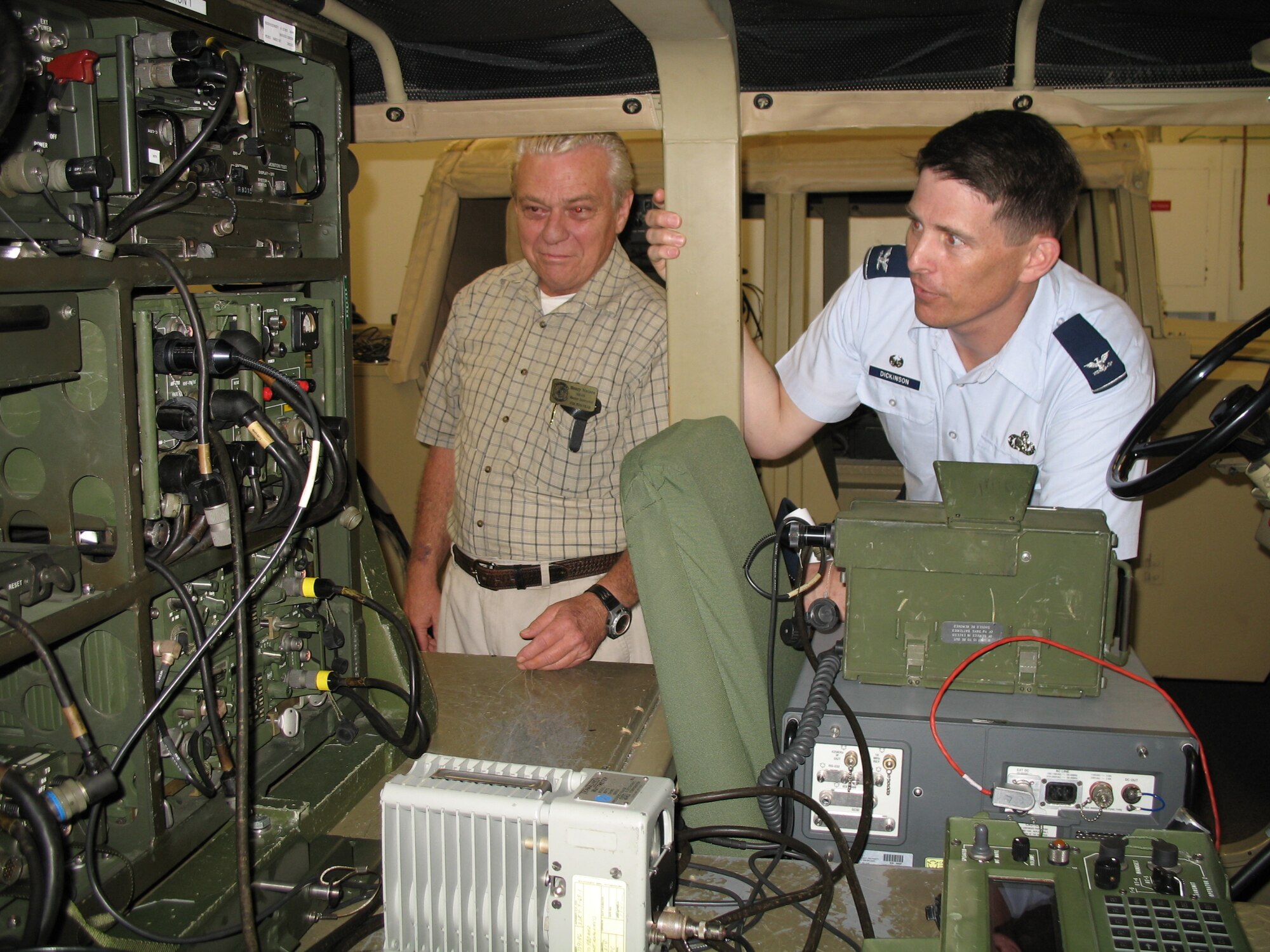 Ground radio instructor Henry Nielsen, left, shows Col. Ian Dickinson, 81st Training Wing commander, how one of two Humvees in a Jones Hall classroom is used to provide more authentic training to students in the 338th Training Squadron.  Colonel Dickinson, who assumed command May 26, toured 81st Training Group facilities and met students and trainers last week.  (U.S. Air Force photo by Werner Lamm)