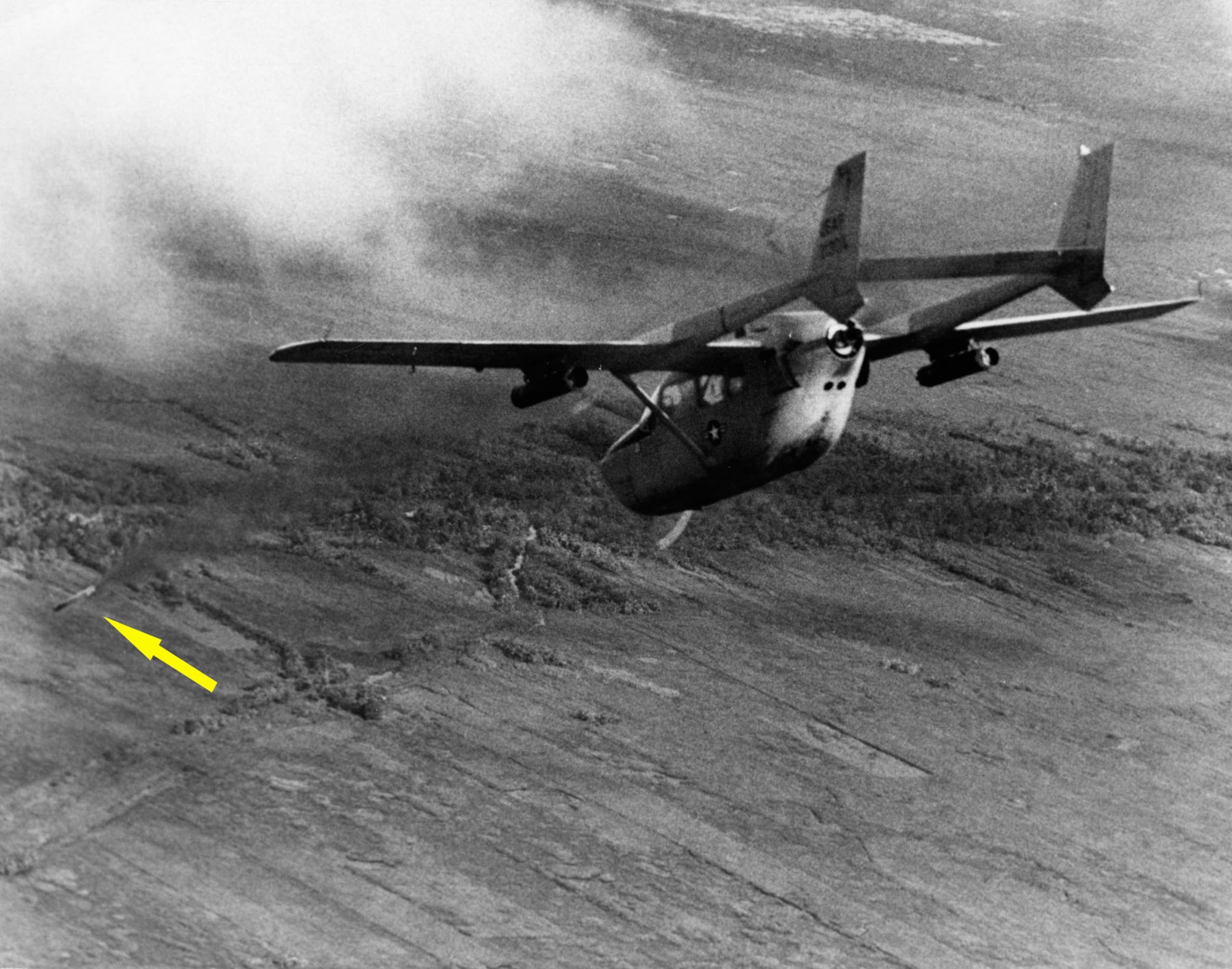 The Cessna O-2A Super Skymaster was used as an interim FAC aircraft and for psychological warfare missions. Here, an O-2A FAC fires a smoke rocket (indicated by the arrow) to mark an enemy stronghold for strike aircraft. (U.S. Air Force photo)