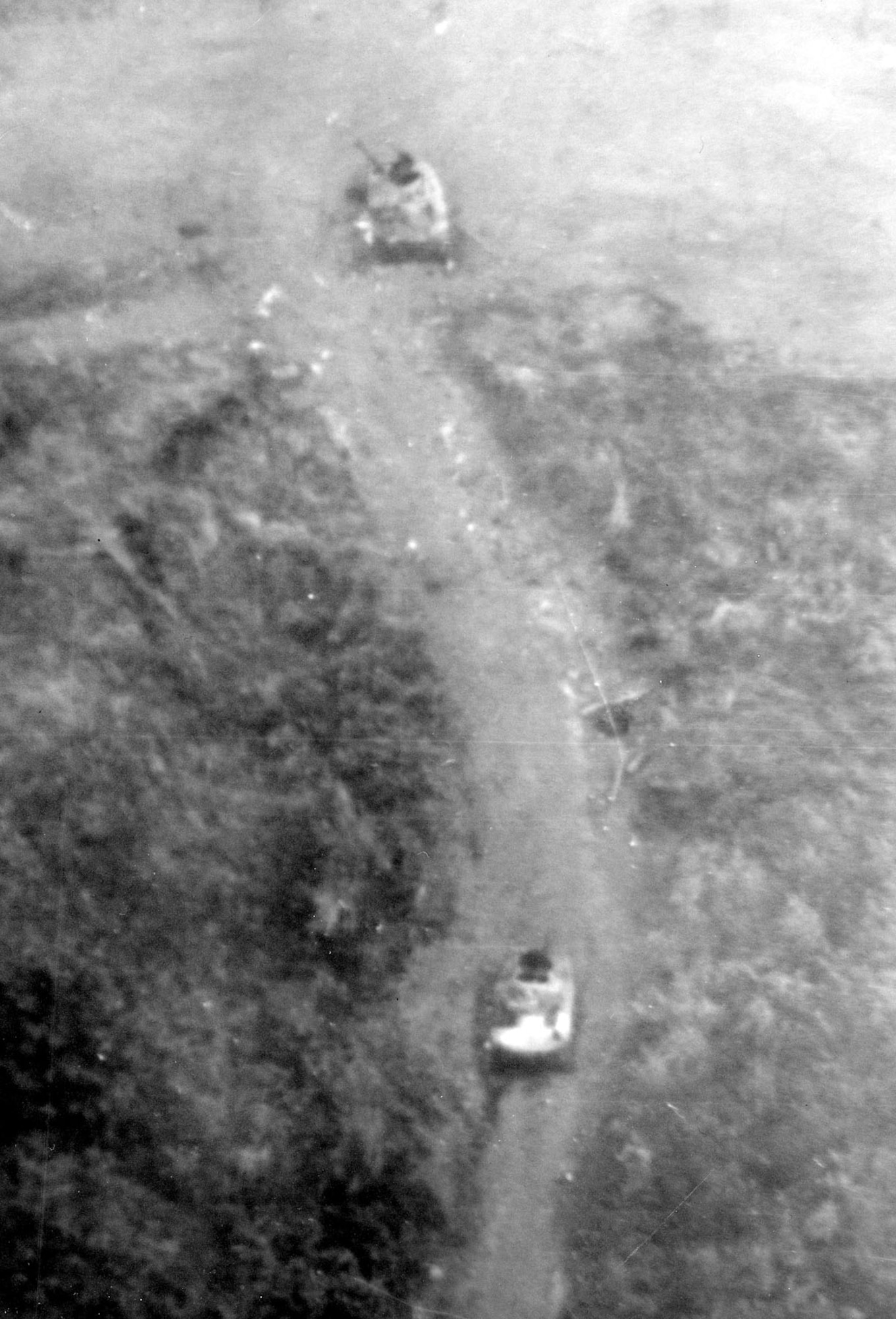 When North Vietnamese Army forces attacked the Special Operations outpost at Lang Vei, near Khe Sanh, in February 1968, FACs assisted the defenders by directing air strikes. In addition, they provided valuable intelligence information. This photograph of two PT-76 tanks disabled on the road leading into Lang Vei proved that the communists were using armored vehicles in South Vietnam. (U.S. Air Force photo)