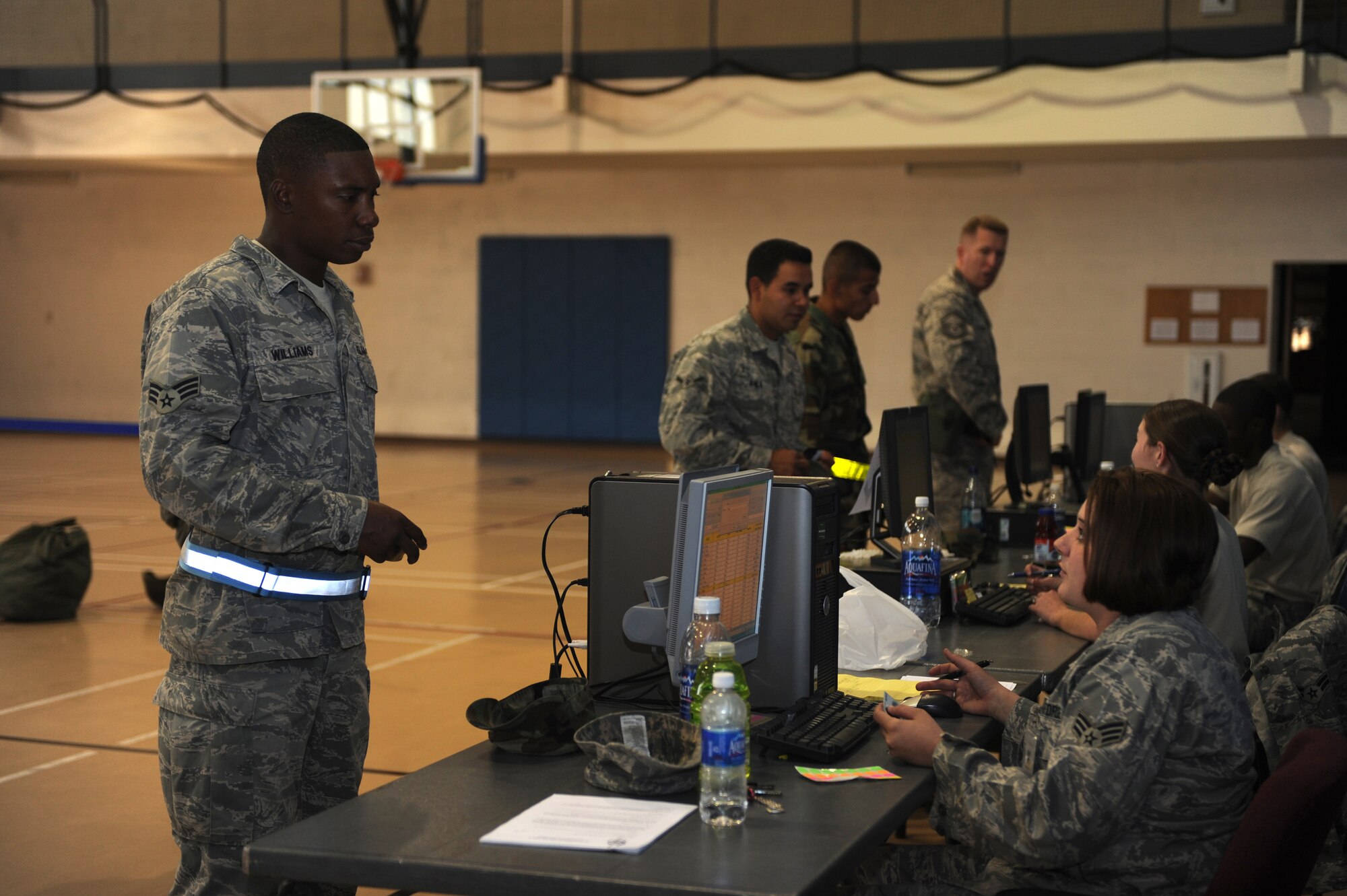 Members of the 49th Force Support Squadron take accountability of Airmen processing through the Apple Orchard during the Phase II exercise at Holloman Air Force Base, N.M., June 15. The Apple Orchard simulates a reception control center which is used in real world deployments. (U.S. Air Force photo/Airman 1st Class Sondra Escutia)