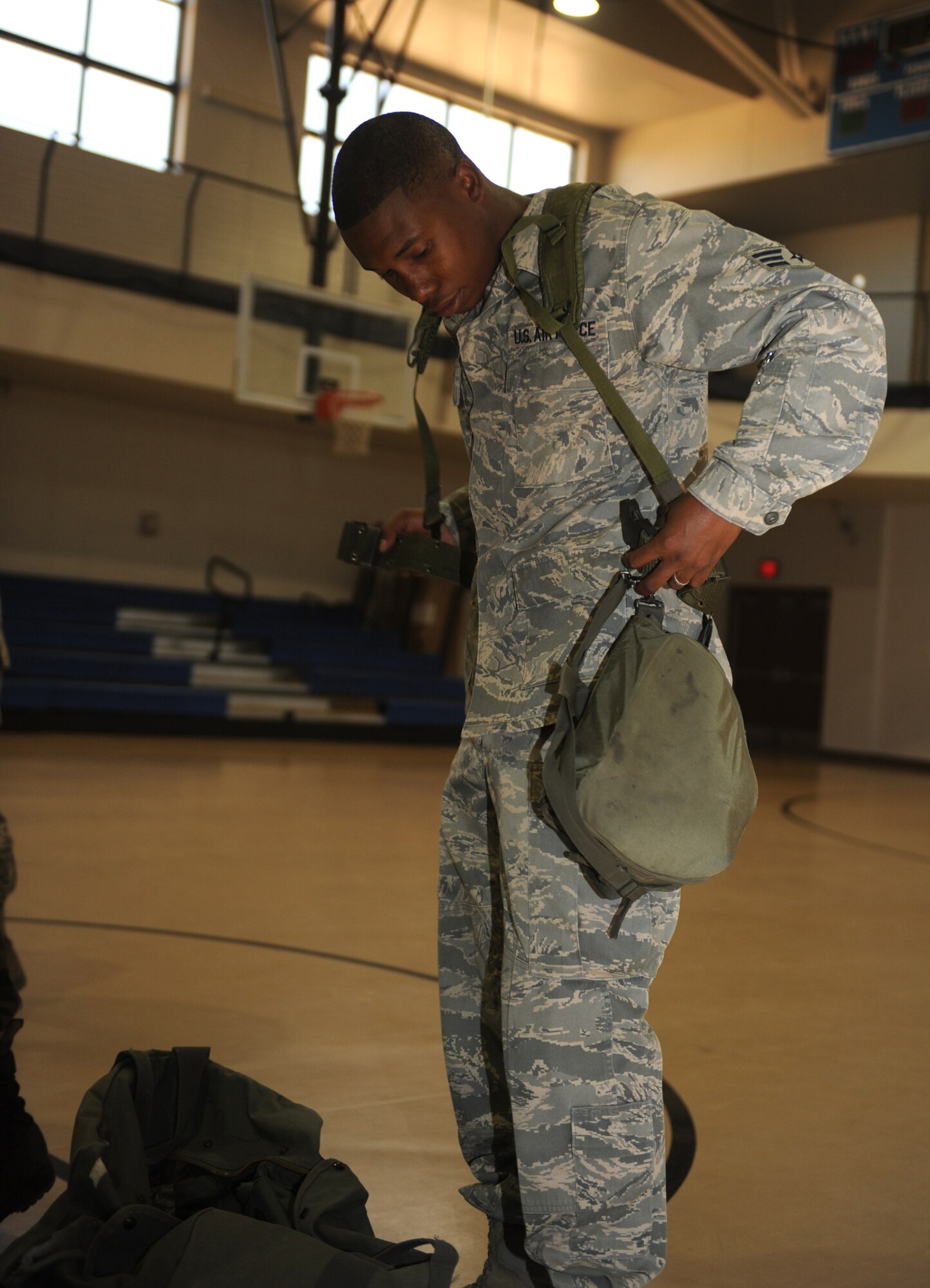 Senior Airman Shaun Williams, 49th Logistics Readiness Squadron, dons the appropriate gear while processing throught the Apple Orchard during the Phase II exercise at Holloman Air Force Base, N.M., June 15. He then proceeded to get on a bus that would take him to his work place in the civil engineer pit. (U.S. Air Force photo/Airman 1st Class Sondra Escutia)