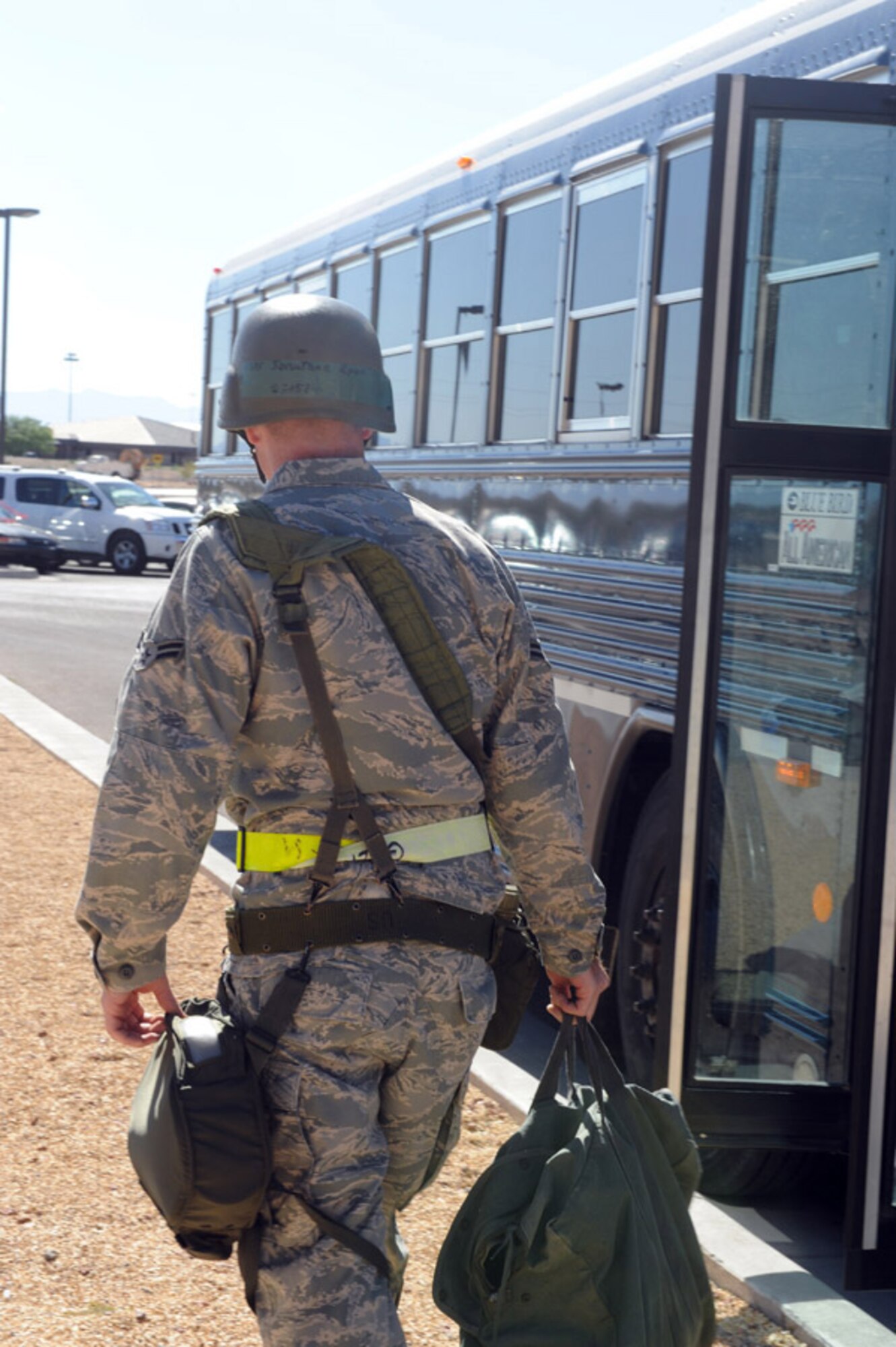 Airman 1st Class Jonathan Ryan, 49th Logistics Readiness Squadron, walks to the bus that will take him to Base X, the civil engineer pit, after processing through the Apple Orchard during the Phase II exercise at Holloman Air Force Base, N.M., June 15. (U.S. Air Force photo/Airman 1st Class Sondra Escutia)