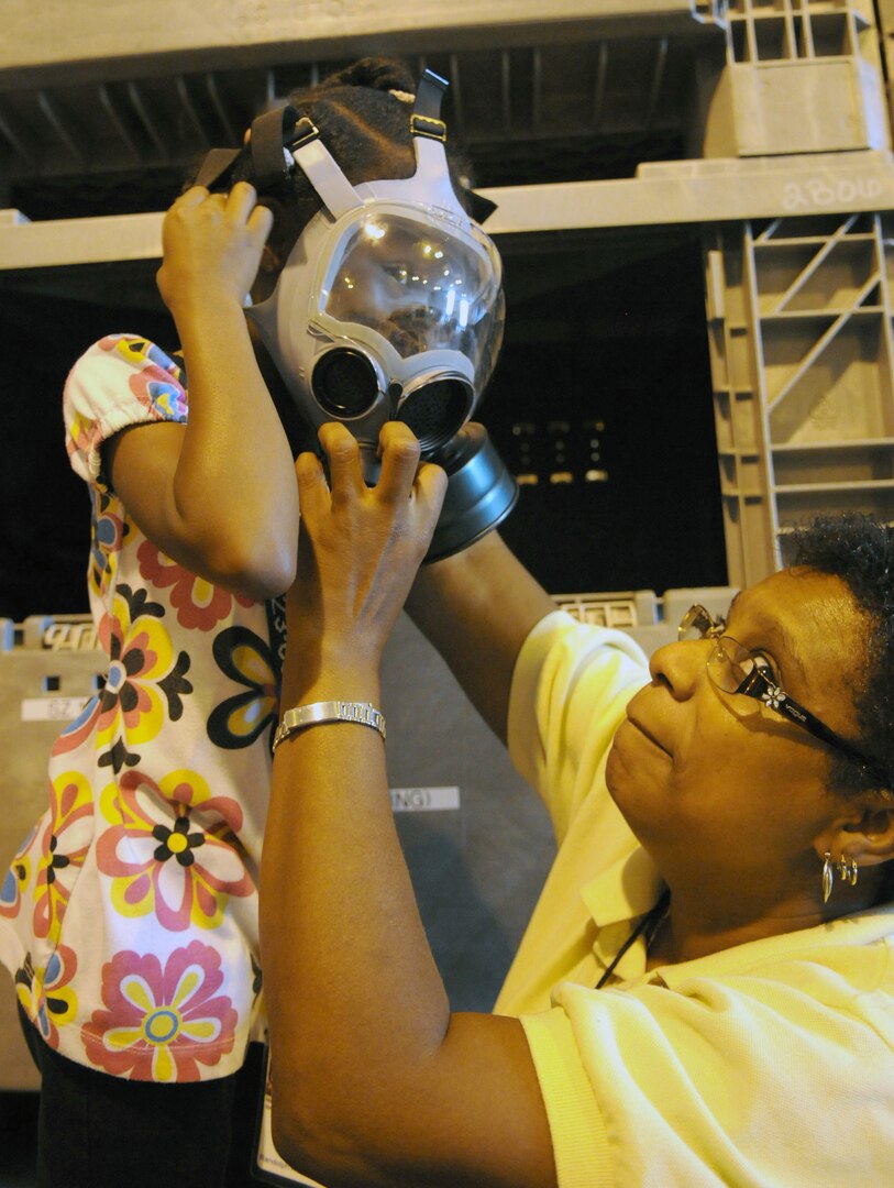 Children got the opportunity to try on military equipment like gas masks, boots and flak jackets during the Airman and Family Readiness Flight's Operation Families Learning About Global Support, or FLAGS, event June 12. Operation FLAGS is a simulated deployment experience for family members to learn what their mom, dad, husband or wife goes through while preparing to deploy. (U.S. Air Force photo by Don Lindsey)