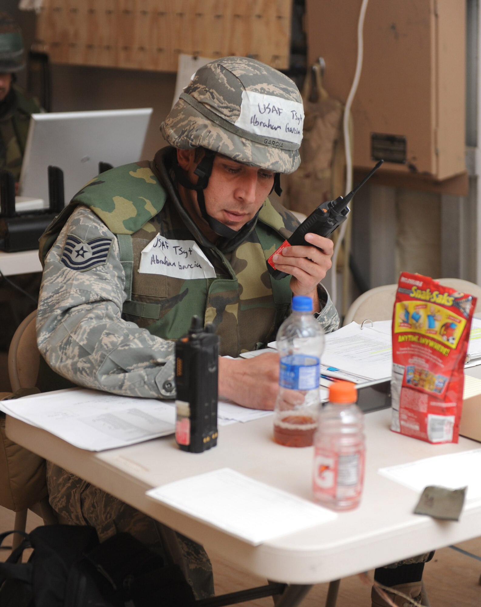 Tech. Sgt. Abraham Garcia, 49th Civil Engineer Squadron, fills out a pre-attack checklist before a simulated aircraft attack during the Phase II exercise at Holloman Air Force Base, N.M. Sergeant Garcia was a member of the unit control center at the civil engineer pit. (U.S. Air Force photo/Airman 1st Class Sondra M. Escutia)