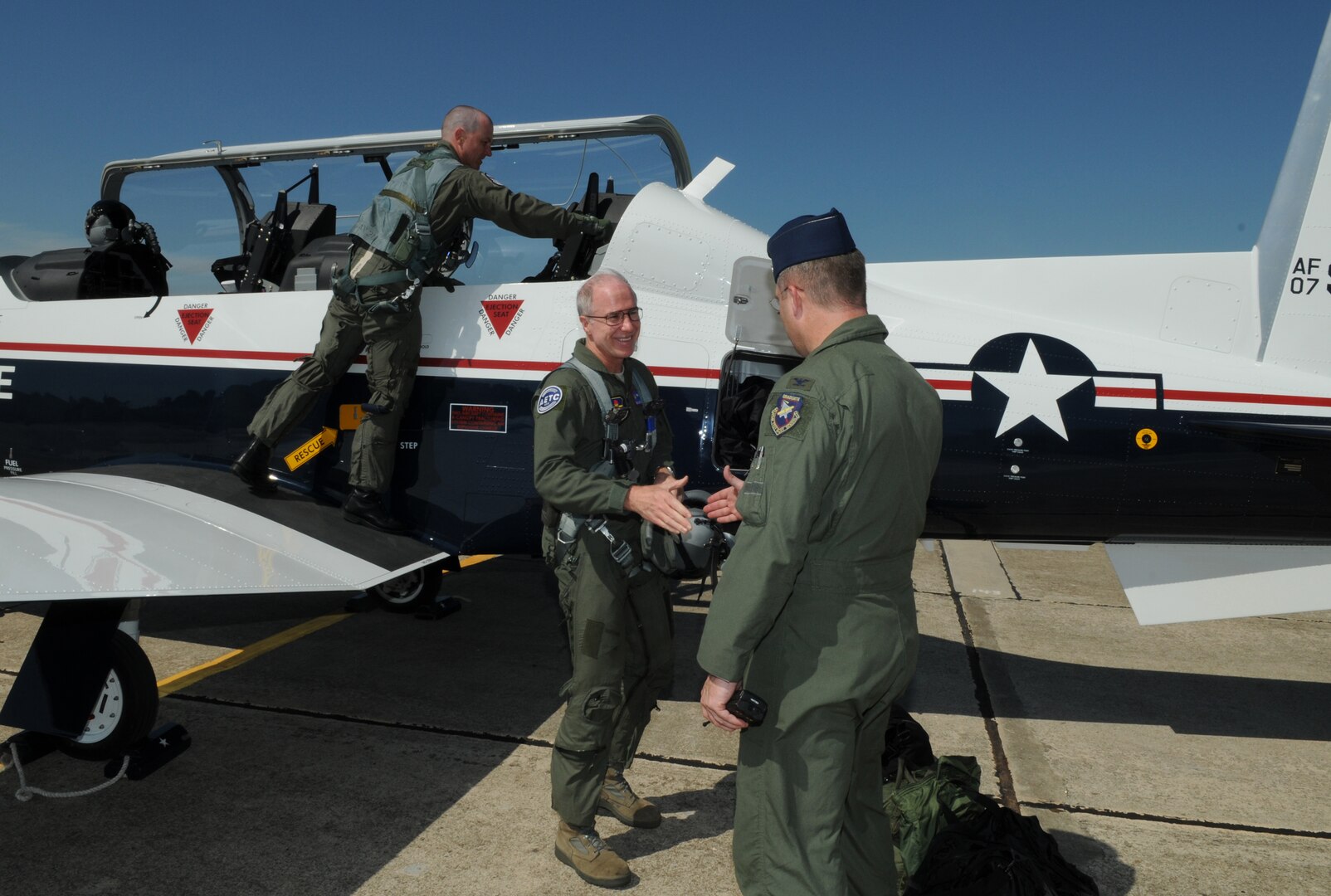 Col. Chris Wellborn, 563rd Flying Training Squadron commander, welcomes Brig. Gen. Richard Devereaux, Air Education and Training Command director of Intelligence, Operations and Nuclear Integration, back to Randolph June 16. General Deveraux delivered a new $4.2 million T-6 to the 12th Flying Training Wing fleet. (U.S. Air Force photo by Rich McFadden)