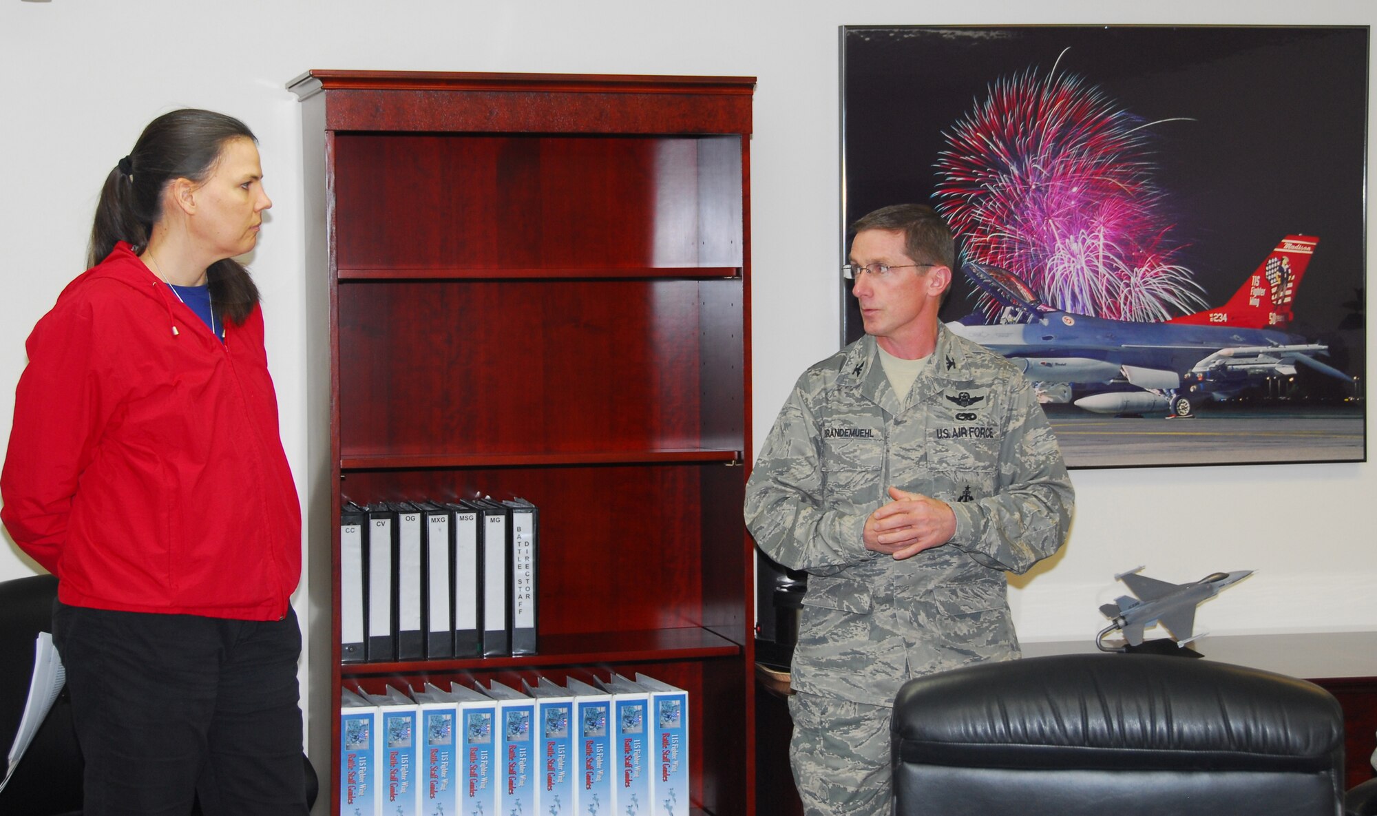 Col. Joseph Brandemuehl, 115th Fighter Wing Commander, talks with Leslie Potack, lead inspector for Occupational Safety and Health Administration's Voluntary Protection Program inspection team at the outbrief May 8. Ms. Potack led a four-person inspection team who evaluated Truax Field in areas of safety, training and hazardous waste management. Following the week-long inspection, the team announced they would be recommending the wing for the VPP-Star, which is OSHA's highest rating. (Photo by Tech. Sgt. Jon LaDue)