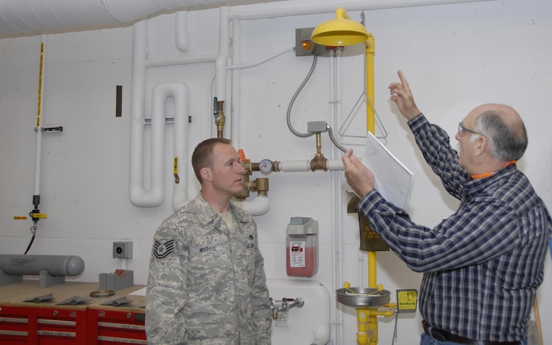 Nick Antonio, a Voluntary Protection Program inspector for the Occupational Safety and Health Administration, talks about emergency eye wash stations with Tech. Sgt. Matt Marose, 115th Maintenance Squadron. Mr. Antonio was part of a four-person inspection team who evaluated Truax Field in areas of safety, training and hazardous waste management. Following the week-long inspection, the team announced they would be recommending the wing for the VPP-Star, which is OSHA's highest rating. (Photo by Master Sgt. Dan Richardson)