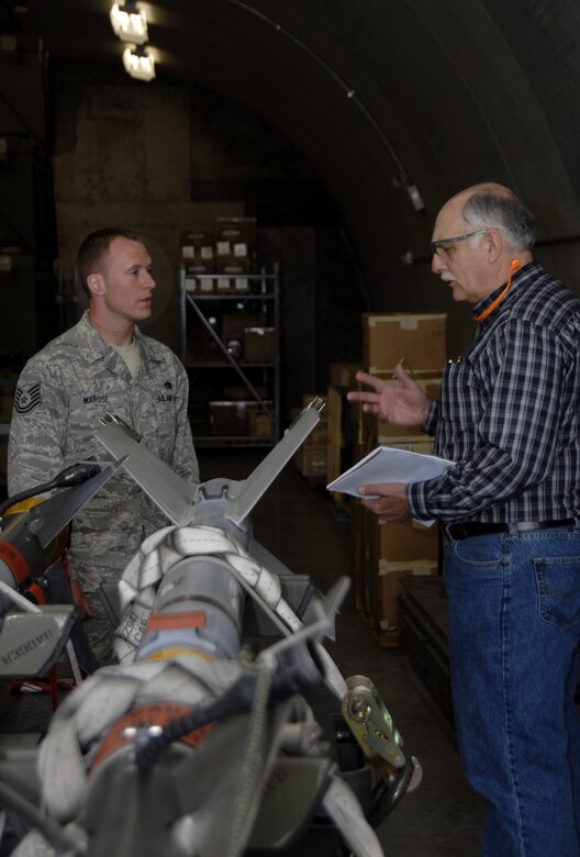 Nick Antonio, a Voluntary Protection Program inspector for the Occupational Safety and Health Administration, talks about processes involved with Truax Field's munitions programs with Tech. Sgt. Matt Marose, 115th Maintenance Squadron. Mr. Antonio was part of a four-person inspection team who evaluated Truax Field in areas of safety, training and hazardous waste management. Following the week-long inspection, the team announced they would be recommending the wing for the VPP-Star, which is OSHA's highest rating. (Photo by Master Sgt. Dan Richardson)