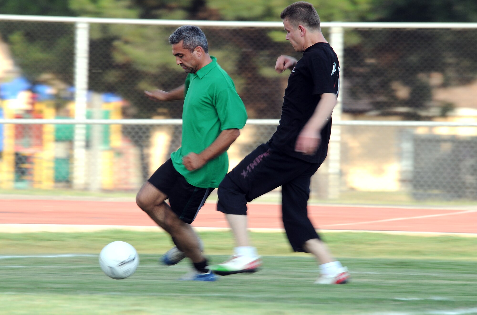 Ali Gulcan, 39th Civil Engineer Squadron, uses his footwork to keep the ball away from Kutlay Uzel, 39th Operations Squadron, during the intramural soccer championship game Tuesday, June 16, 2009, Incirlik Air Base, Turkey. The victory is worth 100 points toward the annual commander’s intramural sport trophy. (U.S. Air Force photo/Airman 1st Class Alex Martinez)
