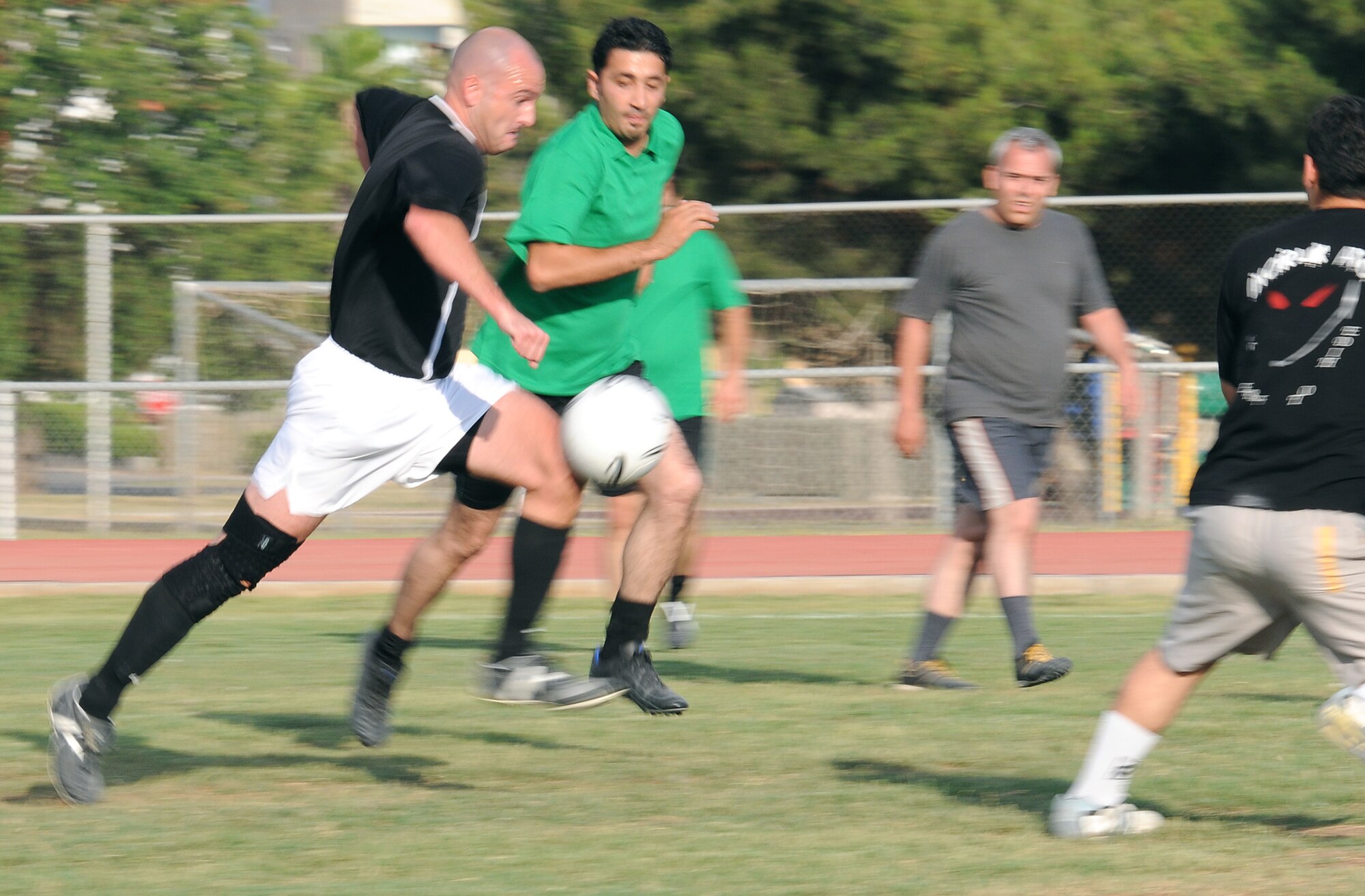Master Sgt. Corey Bowen, 39th Operations Squadron, drives the ball past a 39th Civil Engineer Squadron defender during the intramural soccer championship game Tuesday, June 16, 2009, Incirlik Air Base, Turkey. The teams played each other June 15, and due to a 39th CES win, an additional game needed to be played to determine the winner. (U.S. Air Force photo/Airman 1st Class Alex Martinez)