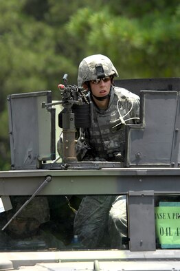 SHAW AIR FORCE BASE, S.C. -- Airman 1st Class Justin Marshall, 20th Security Forces Squadron, searches for opposing forces as he clears a simulated cantonment area for Team Shaw's operational readiness inspection, June 15. The ORI will evaluate the training and preparedness of Shaw's Airmen for homeland attack and worldwide deployment. (U.S. Air Force photo/Senior Airman Kathrine McDowell)
