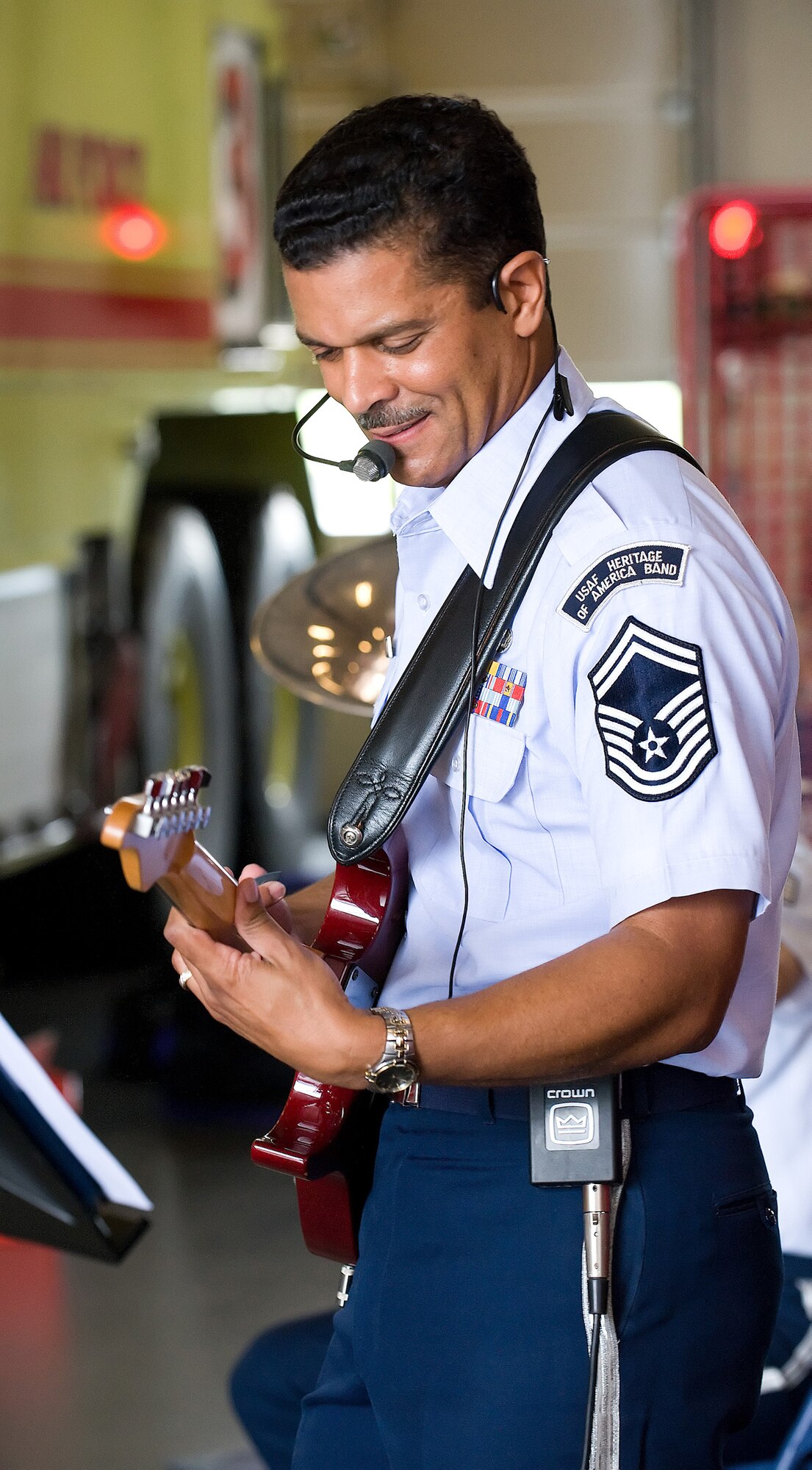 Senior Master Sgt. Ballard Sully plays the guitar during a performance at the Fire Station on Dover Air Force Base June 15. Sergeant Sully is the non-commissioned officer in charge of Vector, a traveling ensemble from the Heritage of America Band stationed at Langley Air Force Base, Va. (U.S. Air Force photo/Tom Randle)