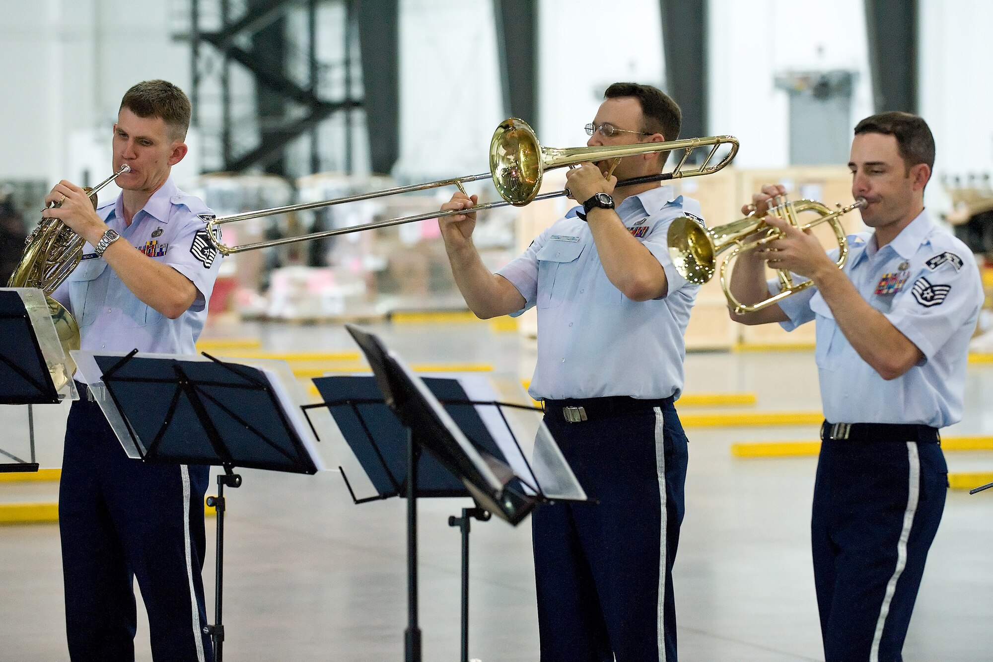 (From left) Master Sgt. Bob Newlin, Staff Sgt. John Garcia and Staff Sgt. Jonathan Rattay, members of the Heritage of America Band traveling ensemble Vector, perform in the Super Port at Dover Air Force Base, Del., June 15. Vector performed at several locations at Dover AFB and the local community as part of a community relations tour that included shows in various venues in Philadelphia. (U.S. Air Force photo/Roland Balik)