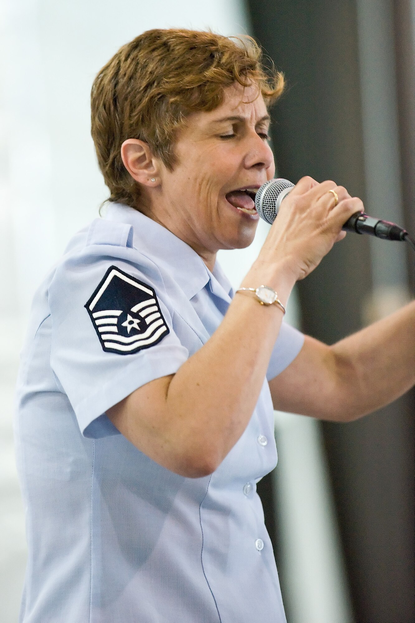 Master Sgt. Verlie Vigil belts out a high note during a performance at the Super Port at Dover Air Force Base, Del., June 15. Sergeant Vigil is a member of Vector, a traveling ensemble from the Heritage of America Band stationed at Langley Air Force Base, Va. (U.S. Air Force photo/Roland Balik)