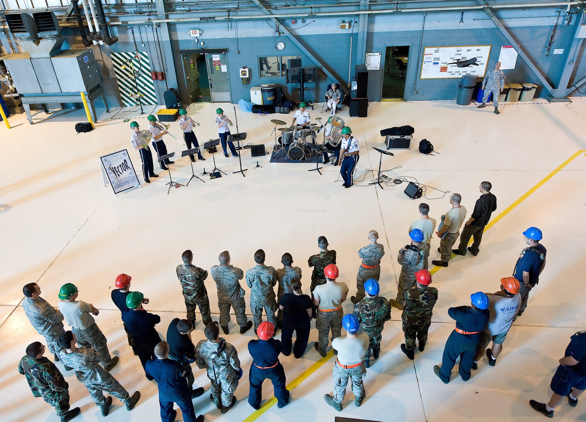 Workers in the Isochronal Inspection Dock at Dover Air Force Base, Del., listen to the msuical group Vector June 15. Vector was created in 2008 in response to the military’s growing need for mobile, troop-focused ensemble. (U.S. Air Force photo/Roland Balik)