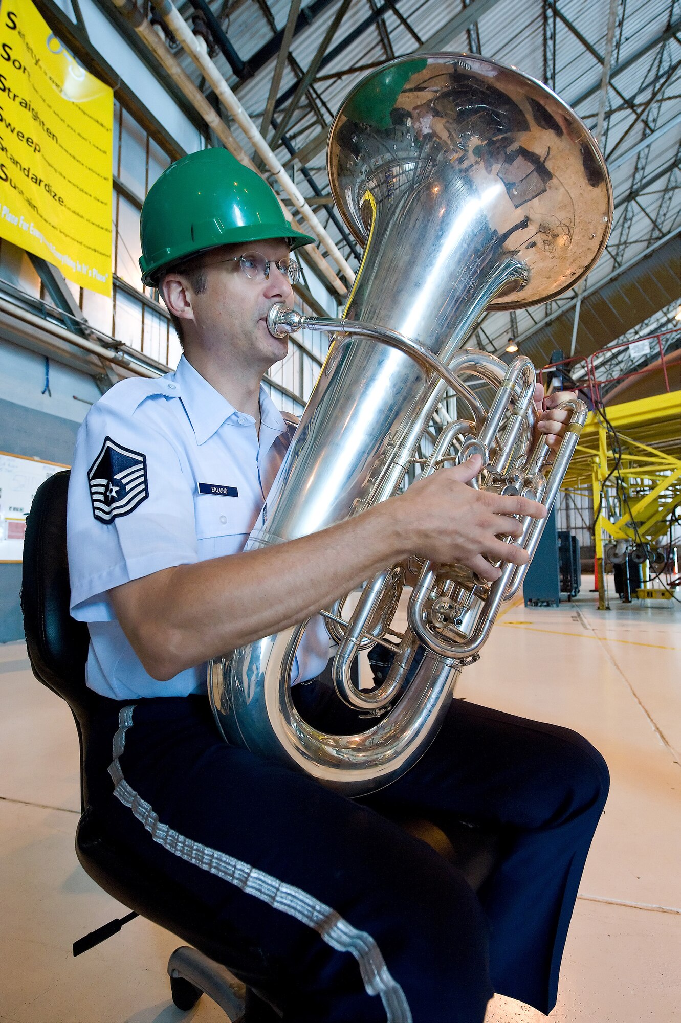 Master Sgt. Steve Eklund, member of the Heritage of America Band traveling ensemble Vector, plays the tuba during a performance at the Isochronal Inspection Dock at Dover Air Force Base, Del., June 15. Vector performed at various locations on Dover AFB June 15. (U.S. Air Force photo/Roland Balik)