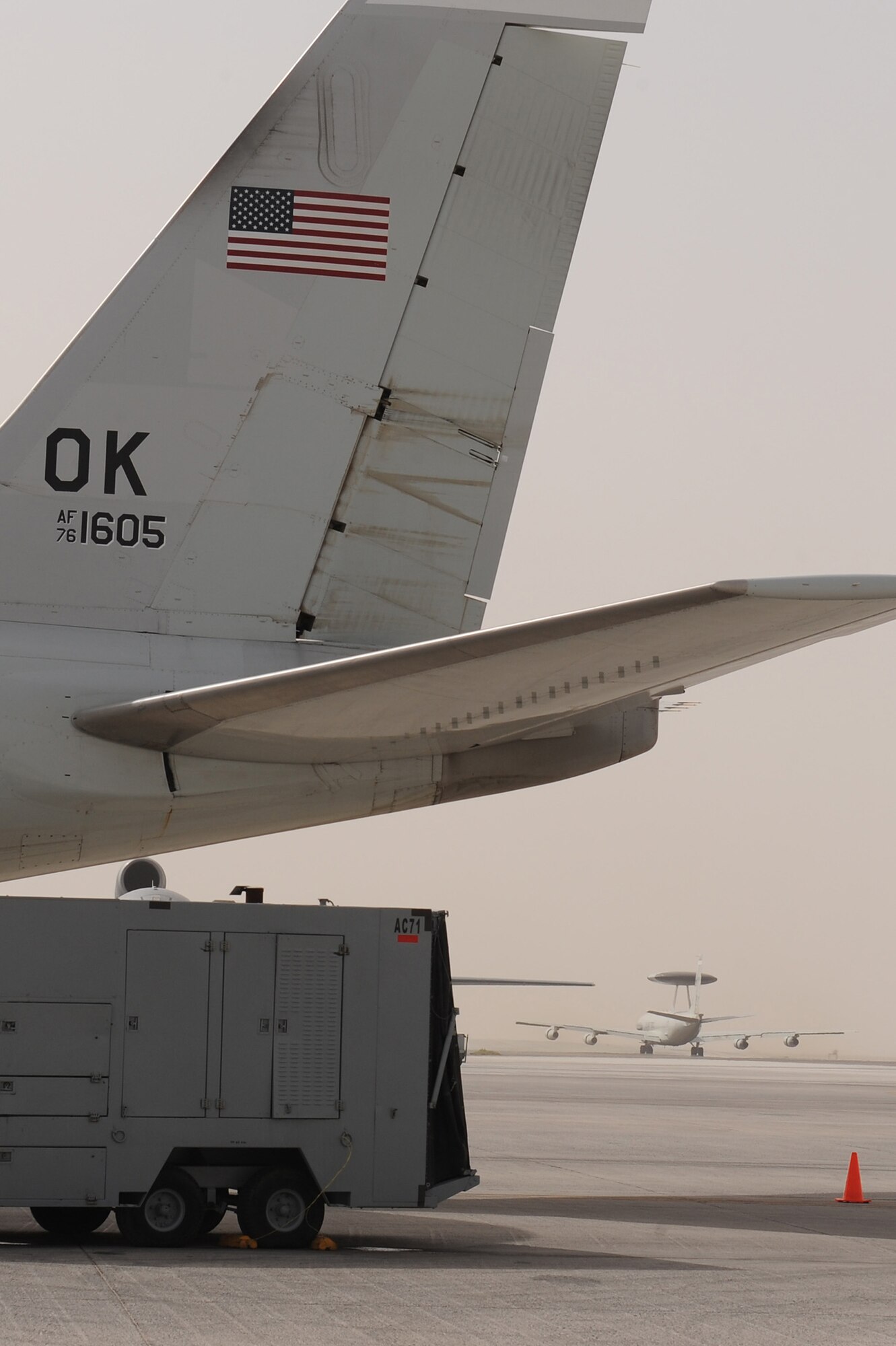 SOUTHWEST ASIA - An E-3 Sentry taxies out for take-off behind the tail wing of another standing ready on the flightline at the 380th Air Expeditionary Wing, June 10 at an undisclosed location in Southwest Asia. The Sentry is one of 3 aircraft critical to the reconnaissance mission at the 380th AEW. Maintainers work around the clock performing maintenance, launching and recovering the aircraft, keeping it flying the tasking order every day. (U.S. Air Force photo by Senior Airman Brian J. Ellis) (Released)