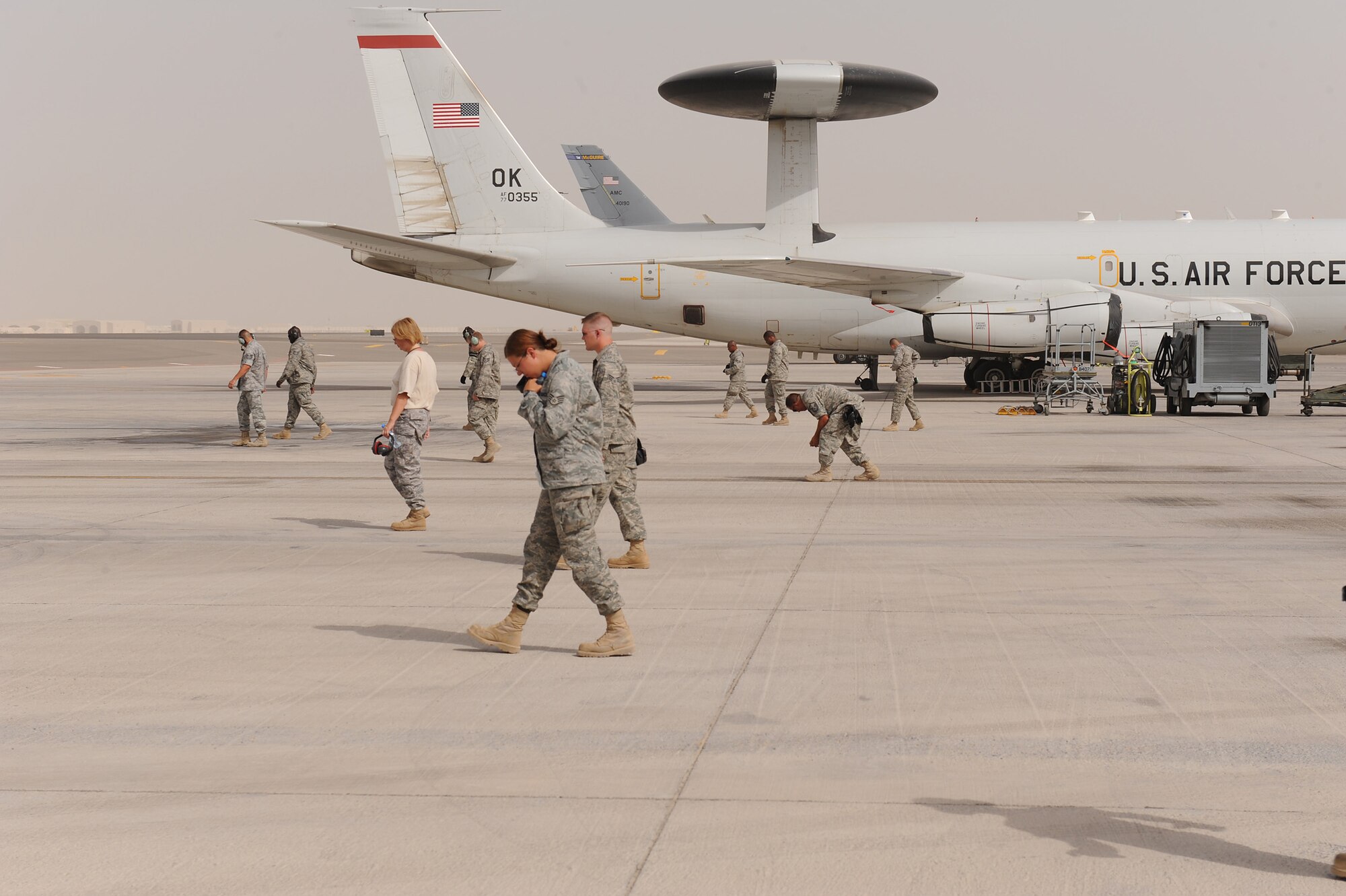 SOUTHWEST ASIA - Maintainers from the 380th Expeditionary Aircraft Maintenance Squadron, Sentry Aircraft Maintenance Unit, perform a foreign object damage prevention walk after launching an E-3 Sentry, June 10 at an undisclosed location in Southwest Asia. The Sentry maintainers work around the clock performing maintenance, launching and recovering the aircraft, keeping it flying the tasking order every day. (U.S. Air Force photo by Senior Airman Brian J. Ellis) (Released)
