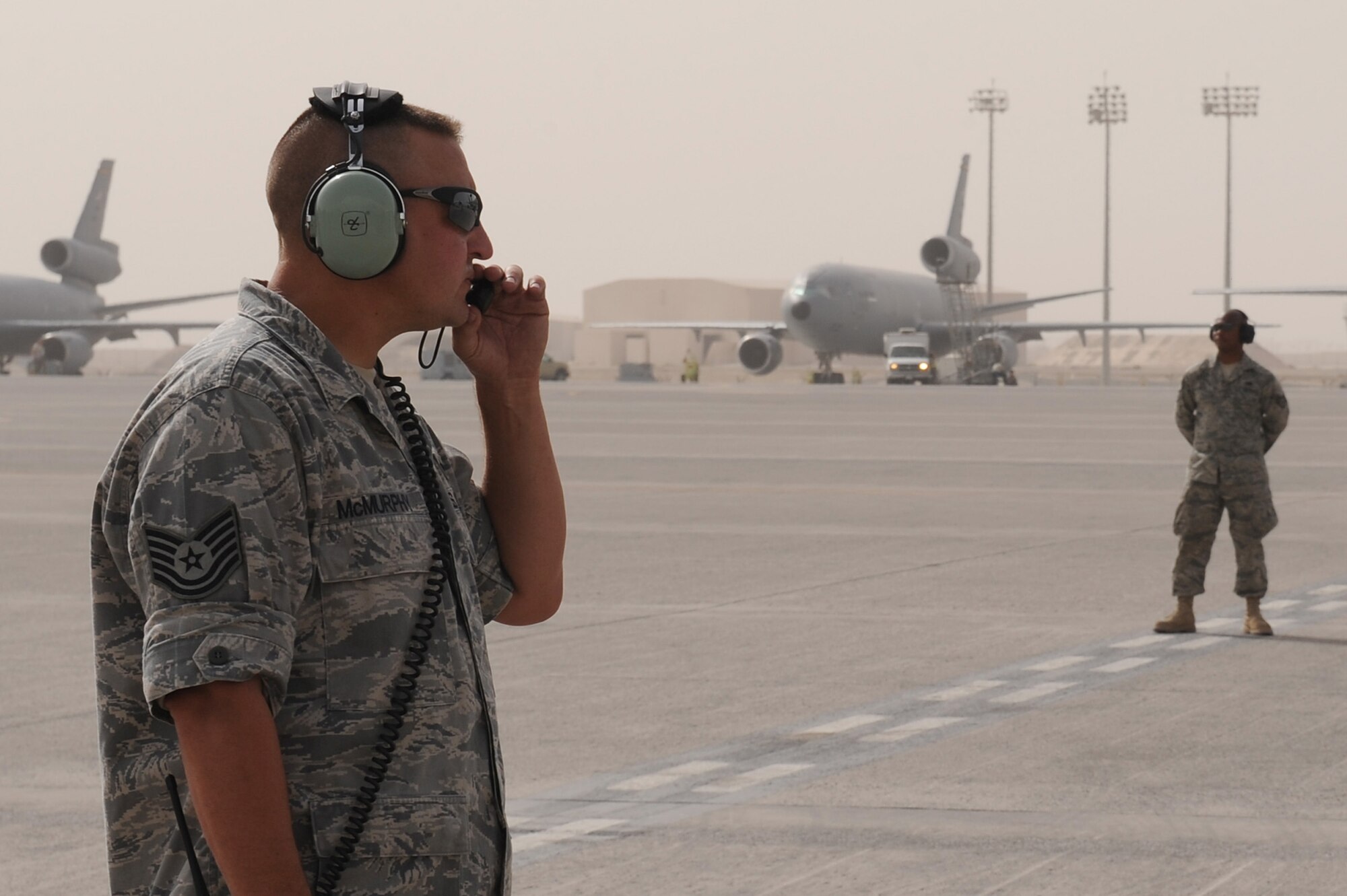 SOUTHWEST ASIA - Tech. Sgt. John McMurphy, 380th Expeditionary Aircraft Maintenance Squadron, Sentry Aircraft Maintenance Unit, communicates with the pilot of an E-3 Sentry prior to its take-off, June 10 at an undisclosed location in Southwest Asia. The Sentry maintainers work around the clock performing maintenance, launching and recovering the aircraft, keeping it flying the tasking order every day. (U.S. Air Force photo by Senior Airman Brian J. Ellis) (Released)