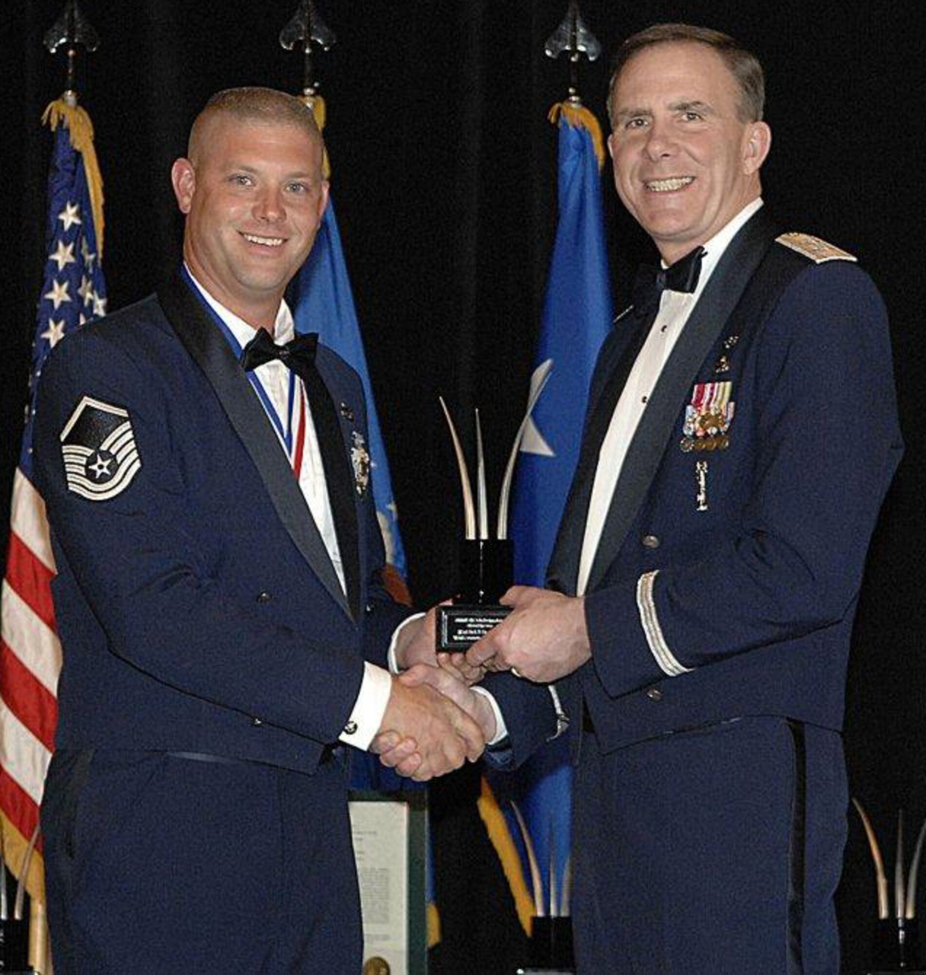 SEYMOUR JOHNSON AIR FORCE BASE, N.C. -- Master Sgt. Dirk Danielson (right) receives the Air Force Reserve Command Vehicle Operations Senior Non-Commissioned Officer of the Year award from Maj. Gen. Robert McMahon. Sgt. Danielson is a Reservist with the 916th Air Refueling Wing and was deployed to Manas Air Base, Kyrgyzstan where he led a 200 plus vehicle fleet and helped transport more than 11,000 passengers.