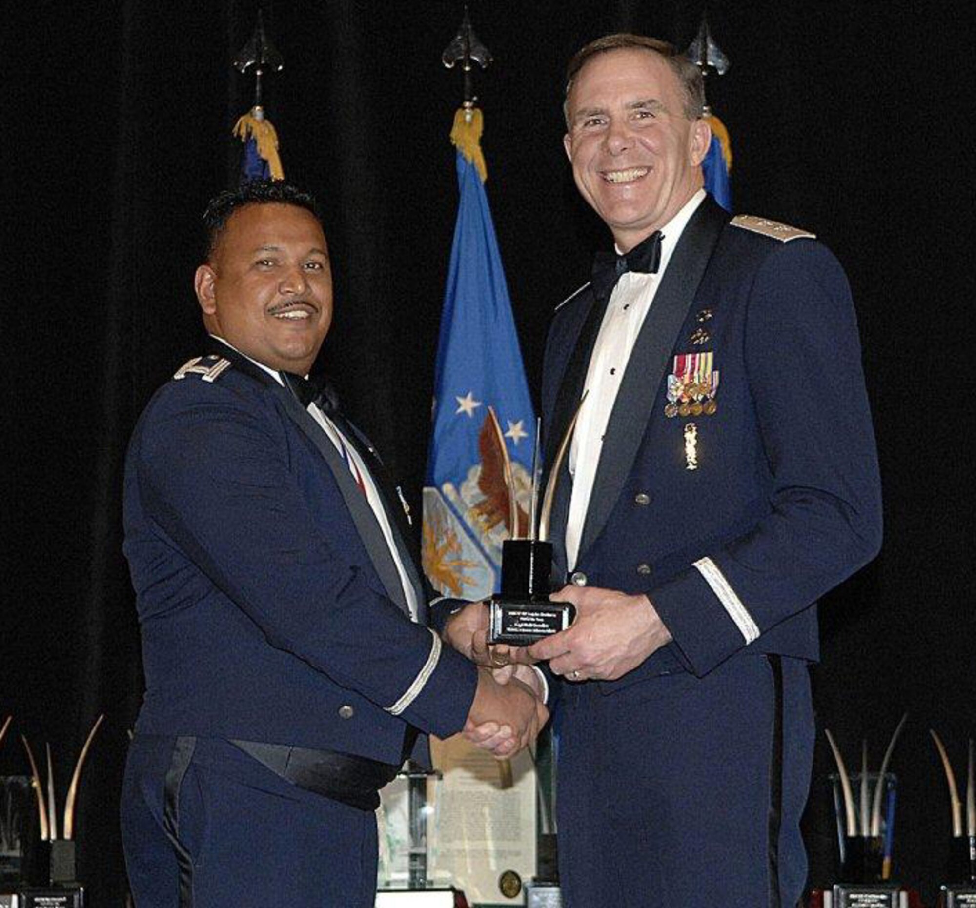 SEYMOUR JOHNSON AIR FORCE BASE, N.C. -- Capt Neil Chandler (left), accepts the Air Force Reserve Command Logistics Readiness Company Grade Officer of the Year award from Maj. Gen. Robert McMahon. Capt. Chandler was a key part of coordinating the singlest largest airdrop in Afghanistan and he led the busiest aerial port flight in Operation Enduring Freedom.