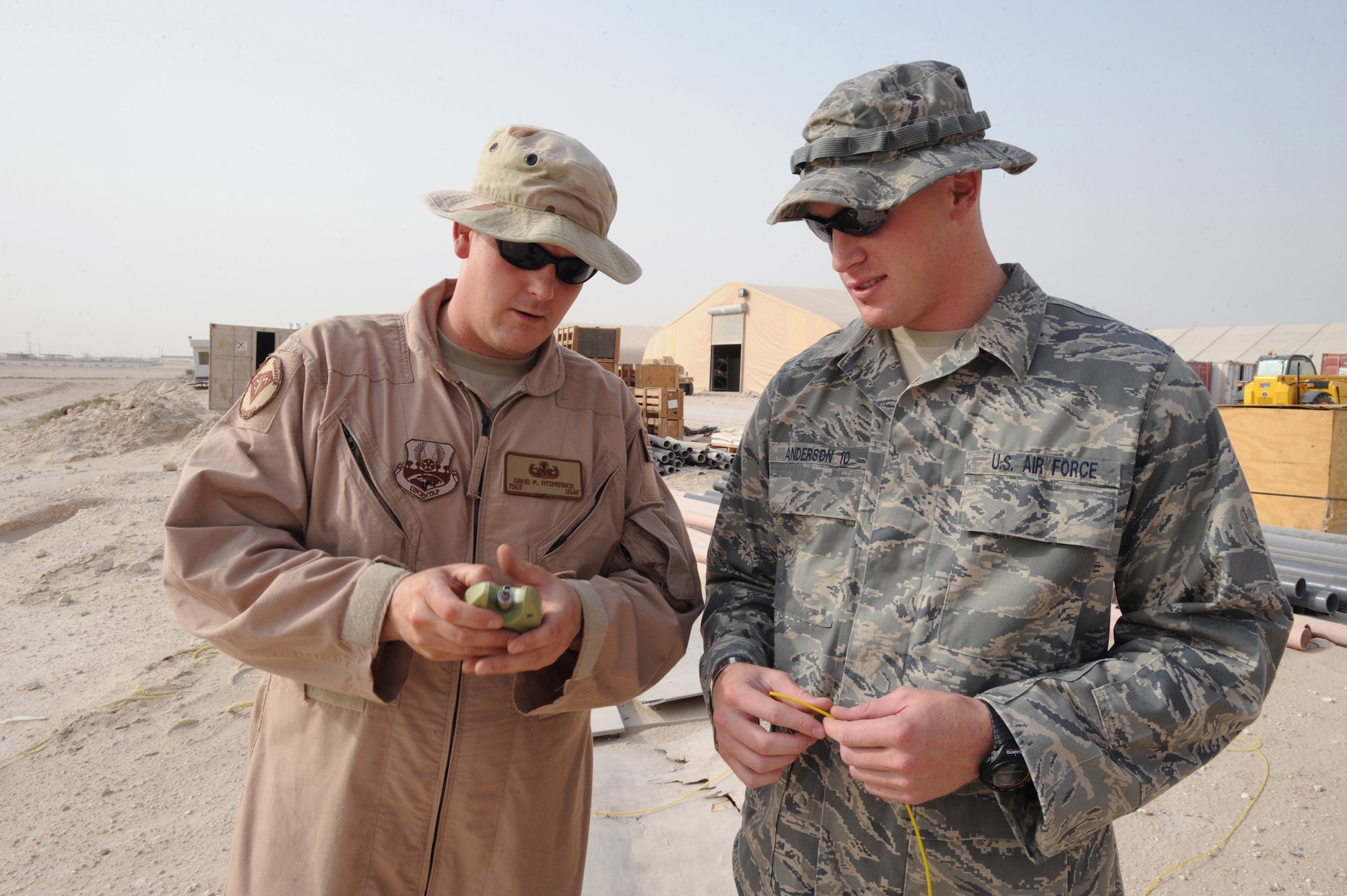 Tech. Sgt. David Fitzpatrick, an explosive ordnance disposal technician with the 379th Expeditionary Civil Engineer Squadron, explains the function of a shock tube igniter to Air Force Academy Cadet Johnson Anderson, June 12, 2009, in an undisclosed location in Southwest Asia.  Cadet Anderson is visiting a deployed squadron as part of Operation Air Force Deployed, which allows cadets to experience various Air Force environments prior to receiving their commission.  Cadet Anderson is from Kearney, Neb. and is visiting from the Air Force Academy, Colo. and Sergeant Fitzpatrick is native to Oak Park, Ill. and is deployed from Ellsworth Air Force Base, S.D., in support of Operations Iraqi and Enduring Freedom and Combine Joint Task Force - Horn of Africa.  (U.S. Air Force Photo by Staff Sgt. Joshua Garcia/released)