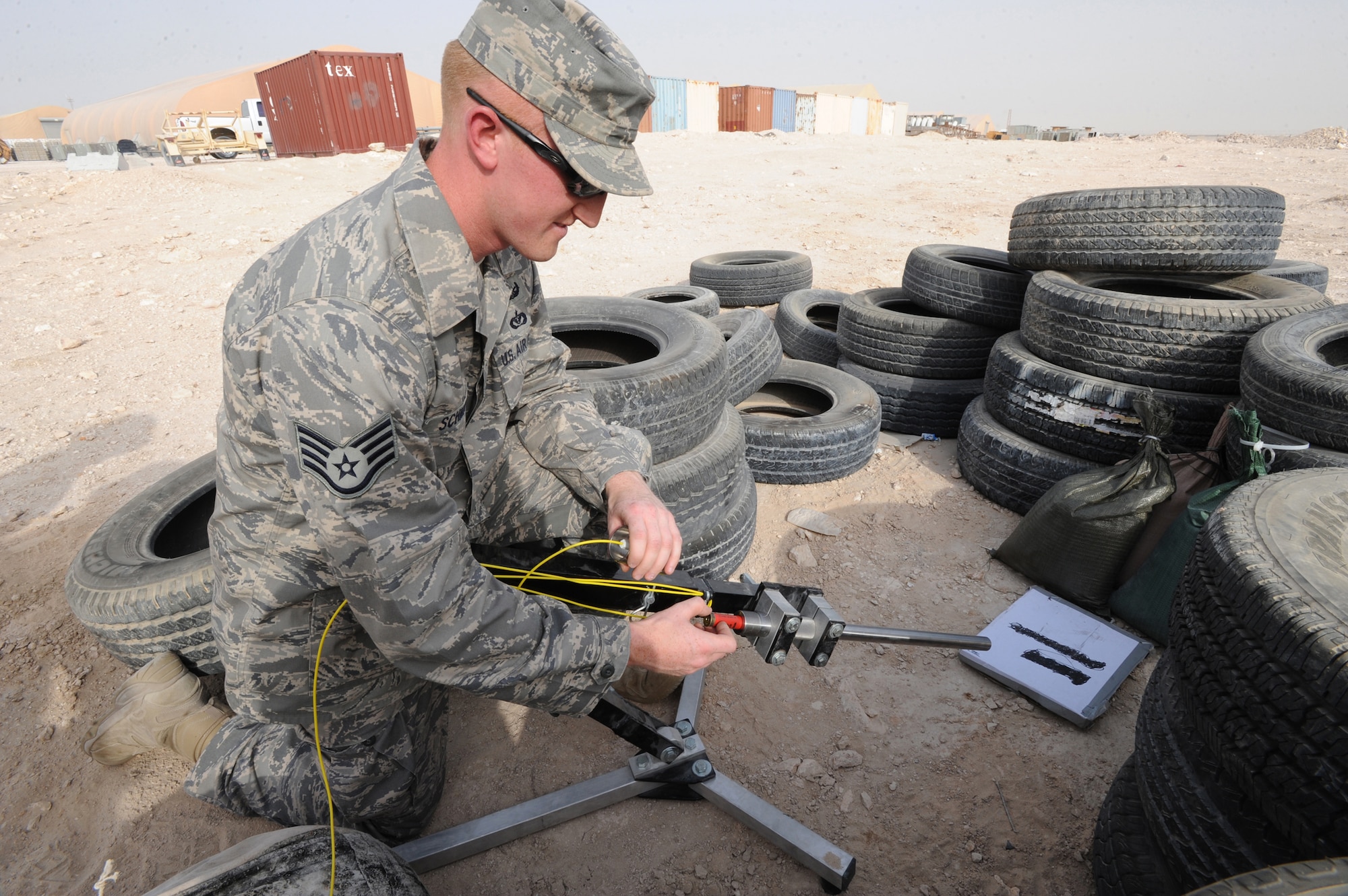Staff Sgt. George Schmalz, an explosive ordnance disposal technician, places a Percussion Actuated Neutralizer (PAN) shell in place during a training scenario, June 12, 2009, in an undisclosed location in Southwest Asia.  The PAN shell is used to project a shot of water out of the tube and into the suspect item.  Sergeant Schmalz hails from Enola, Penn. and is deployed from Charleston Air Force Base, S.C., in support of Operations Iraqi and Enduring Freedom and Combine Joint Task Force - Horn of Africa.  (U.S. Air Force Photo by Staff Sgt. Joshua Garcia/released)