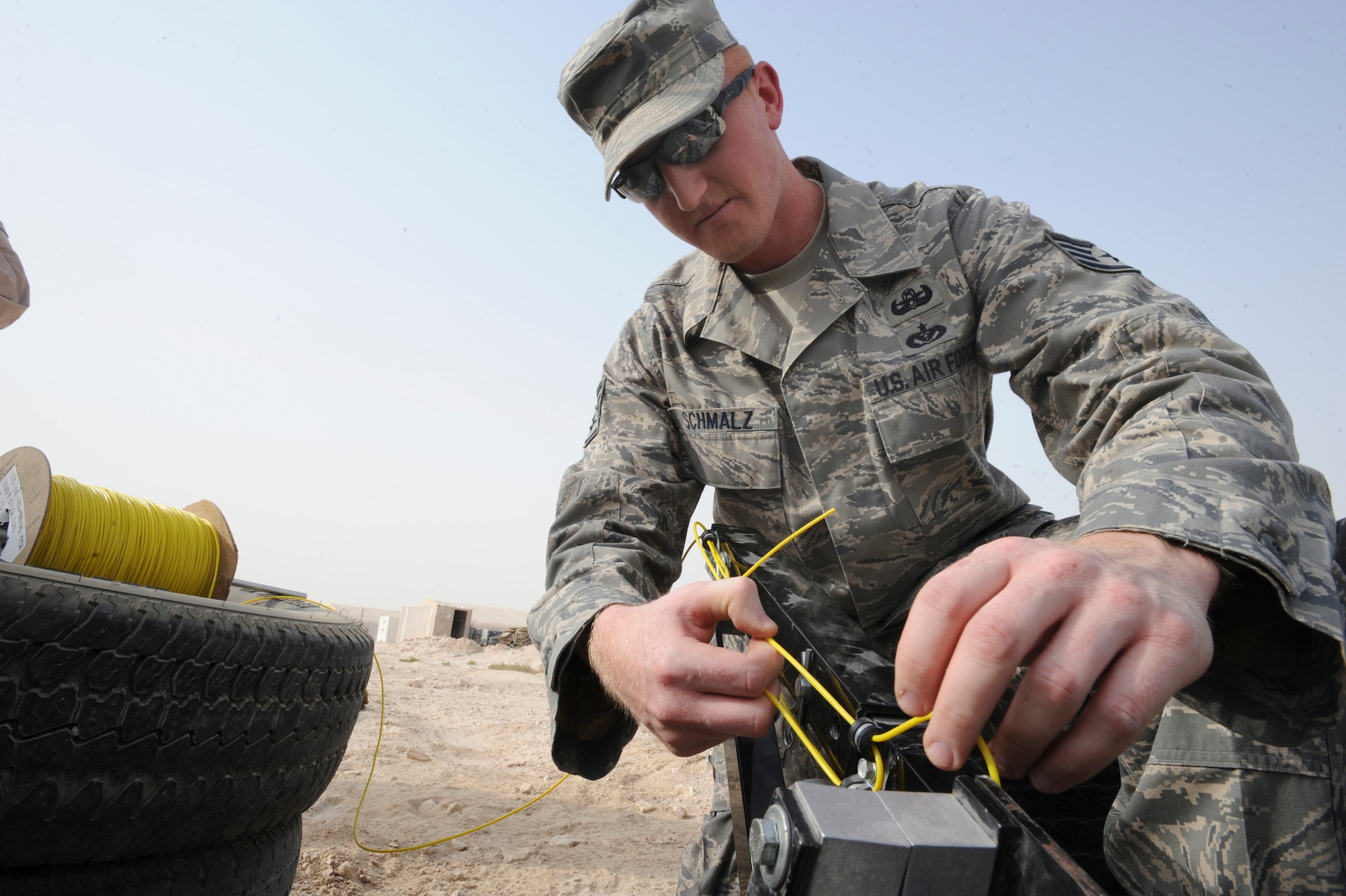 Staff Sgt. George Schmalz, an explosive ordnance disposal technician, places a Percussion Actuated Neutralizer (PAN) shell in place during a training scenario, June 12, 2009, in an undisclosed location in Southwest Asia.  The PAN is an alternate method used by EOD personnel to disarm explosives. Sergeant Schmalz hails from Enola, Penn. and is deployed from Charleston Air Force Base, S.C., in support of Operations Iraqi and Enduring Freedom and Combine Joint Task Force - Horn of Africa.  (U.S. Air Force Photo by Staff Sgt. Joshua Garcia/released)
