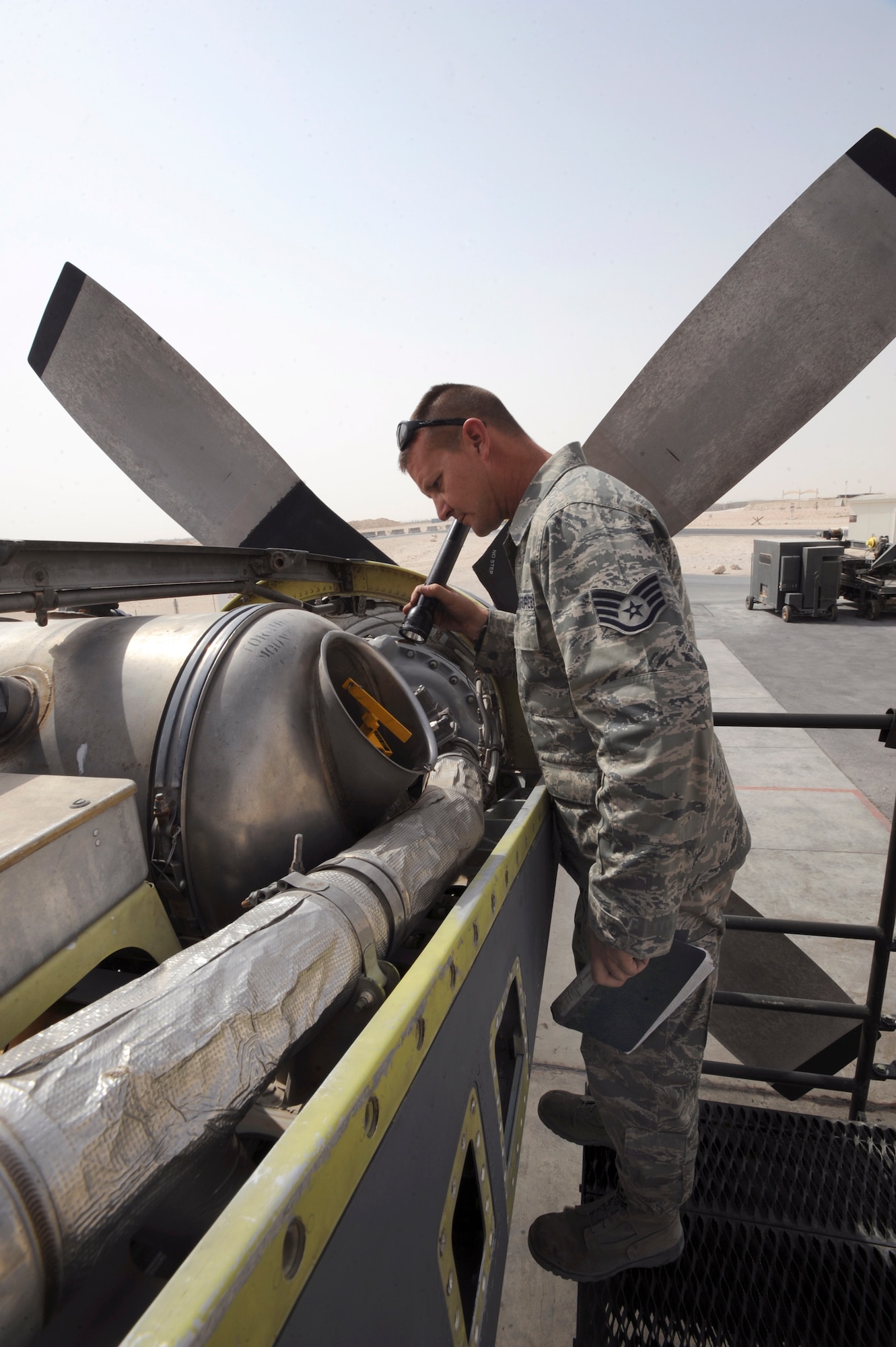 Tech. Sgt. Richard Replinger, a turbo propulsion craftsman with the 379th Expeditionary Maintenance Squadron performs a pre-run inspection on a C-130H Hercules engine prior to starting a test run, June 14, 2009, in an undisclosed location in Southwest Asia.  The test cell is the only T56 testing rig in the U.S. Central Command's area of responsibility, which allows engine tests to be carried out here in the AOR instead of going back to Ramstein AB, Germany.  Sergeant Replinger is native to Fayetteville, N.C. and is deployed from Hurlburt Field Air Force Base, Fla., in support of Operations Iraqi and Enduring Freedom and Combine Joint Task Force - Horn of Africa.  (U.S. Air Force Photo by Staff Sgt. Joshua Garcia/released)