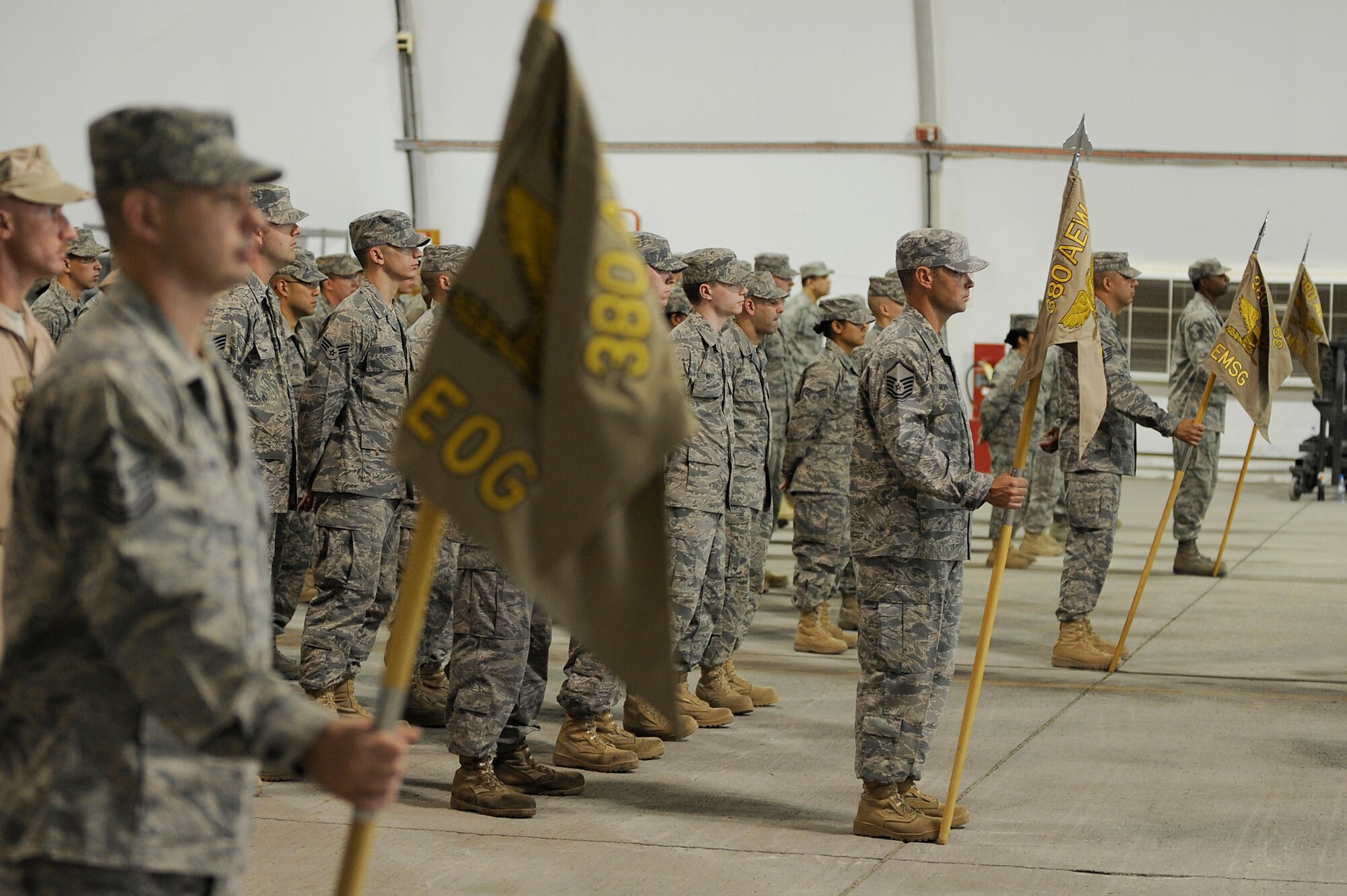 SOUTHWEST ASIA - Airmen of the 380th Air Expeditionary Wing stand in their respective group's formation during a Wing Change of Command ceremony, June 14 at an undisclosed location in Southwest Asia. Lt. Gen Gary North, commander, Air Forces Central, presented command to Brig. Gen. Bryan Benson. General Benson comes from Scott AFB, Ill. as the vice commander for the 618th Tanker Airlift Control Center, to lead the Airmen of the 380th AEW. (U.S. Air Force photo by Senior Airman Brian J. Ellis) (Released)