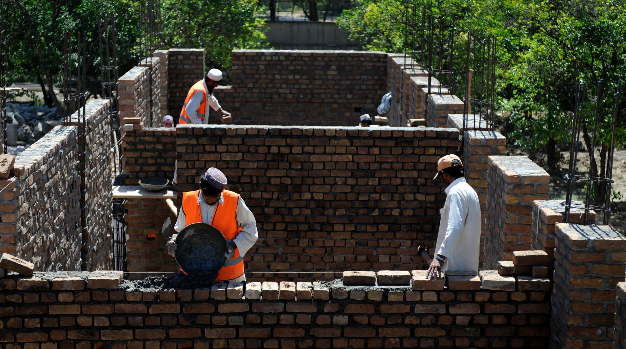 Local contractors spread mortar for a development site May 30, 2009, in Nangarhar Province, Afghanistan. The development is monitored by the Nangarhar Provincial Reconstruction Team, Forward Operating Base Finley-Shields, Afghanistan.  The PRT is responsible for development and reconstruction projects in Nangarhar Province. The projects are built by local and contractors and are designed to improve the livelihood of the people living in the area. (U.S. Air Force Photo by Staff. Sgt. Shawn Weismiller)