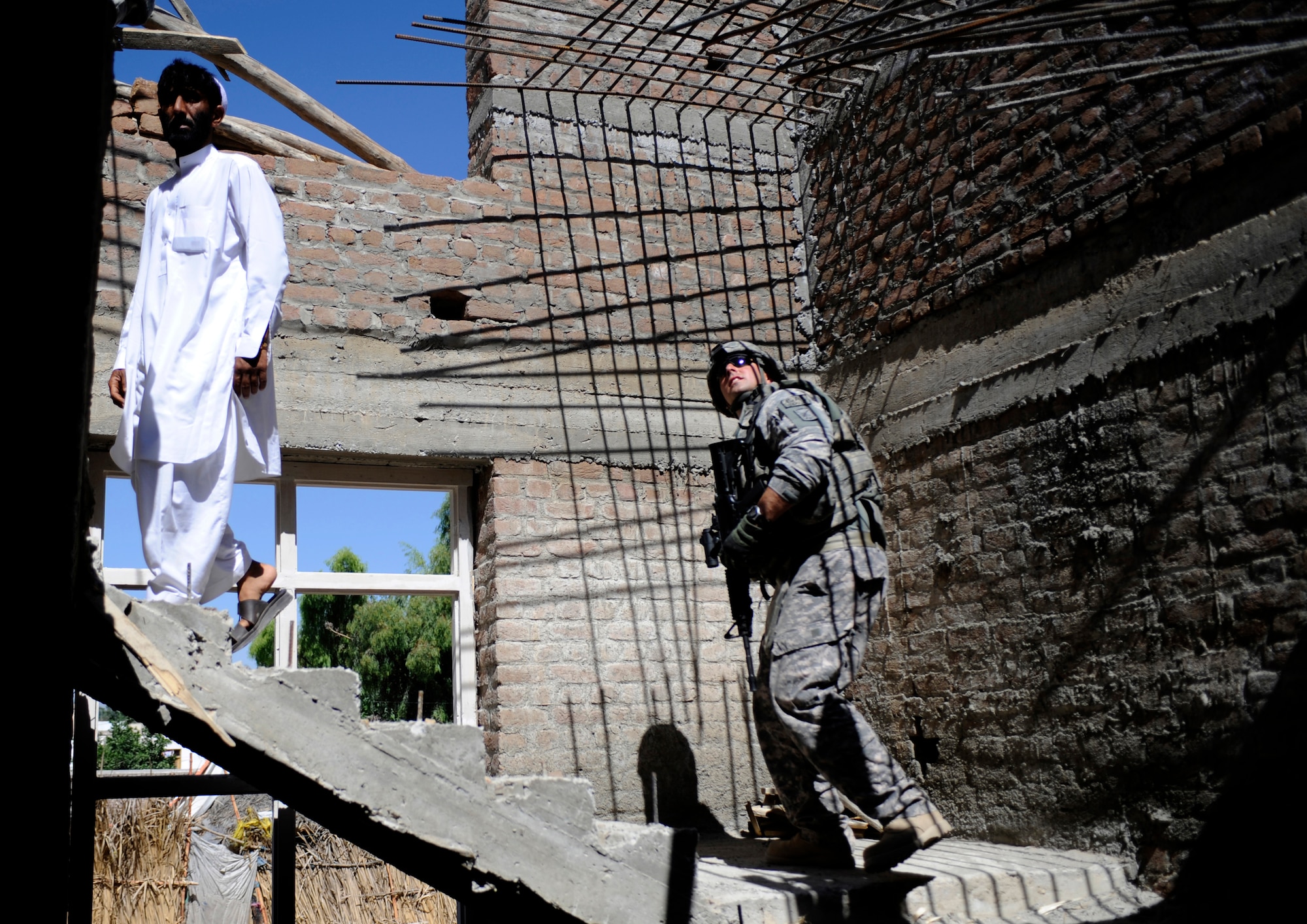 Tech. Sgt. Bryan Calaman, Nangarhar Provincial Reconstruction Team engineer, conducts a quality assurance inspection of a development site May 30, 2009, in Nangarhar Province, Afghanistan. The PRT is responsible for development and reconstruction projects in Nangarhar Province. The projects are built by local and contractors and are designed to improve the livelihood of the people living in the area. Sergeant Calaman is deployed from the 37th Civil Engineering Squadron, Lackland Air Force Base, Texas.  (U.S. Air Force Photo by Staff. Sgt. Shawn Weismiller)